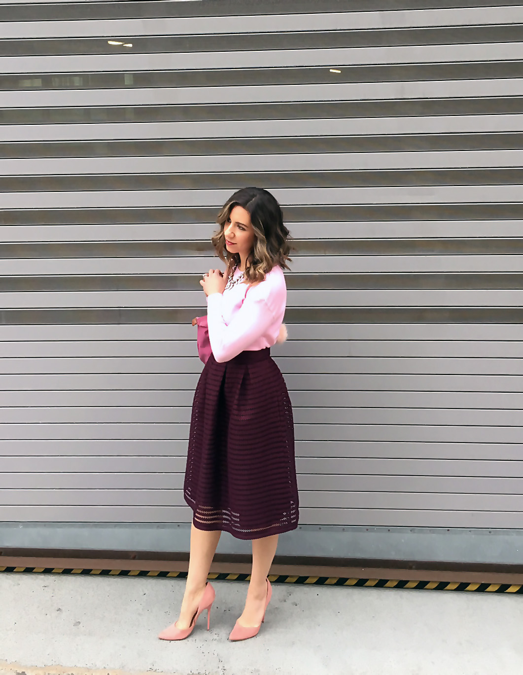 Pink Valentines Day Look featured by top US fashion blog, Glass of Glam: image of a woman wearing a pink SheIn sweater, Charlotte Russe midi skirt, pink Longchamp bag, JustFab heels, and a BaubleBar statement necklace