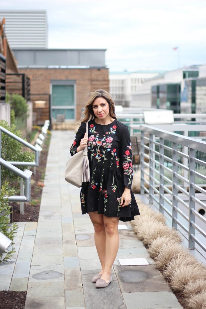 Lifestyle Blogger Roxanne Birnbaum of Glass of Gla wearing a Zaful embroidered black dress, Cuore & Pelle hobo bag, and M.Gemi flats