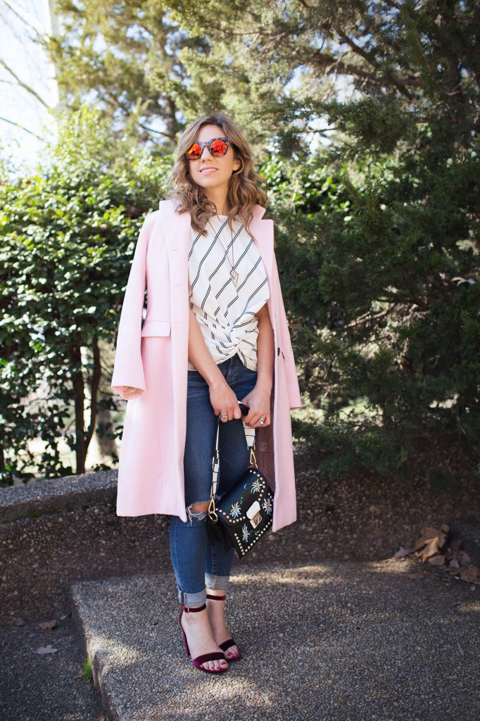 Style Blogger Roxanne Birnbaum of Glass of Glam wearing a SugarLips striped top, AG denim, Amazon Fashion pink coat, a Zaful bag, and Vye Eyewear Sunglasses