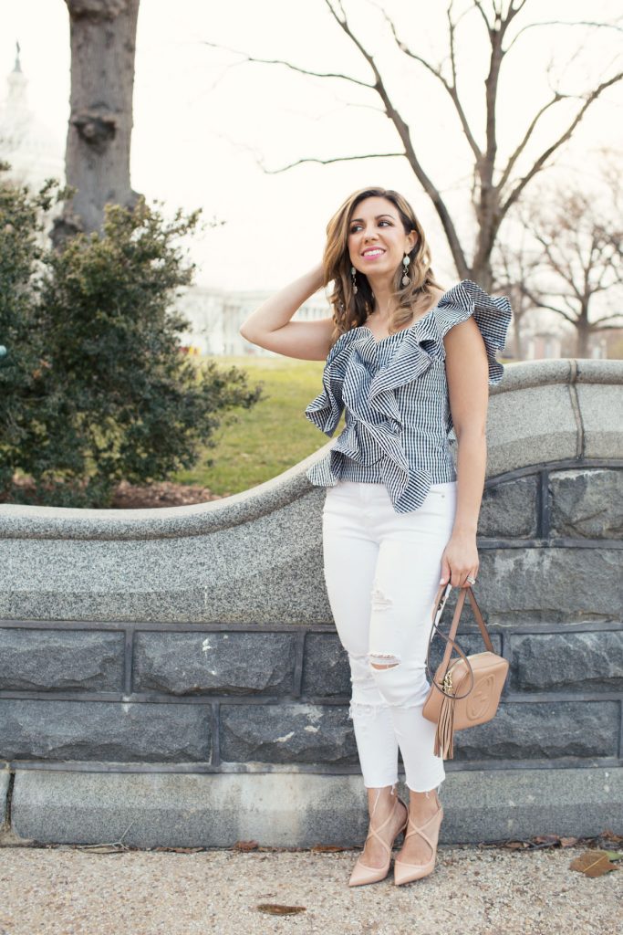 Lifestyle Blogger Roxanne of Glass of Glam wearing a Blush & Stone Boutique ruffled gingham top, Old Navy denim, Christian Louboutin heels, and a Gucci Soho Disco bag