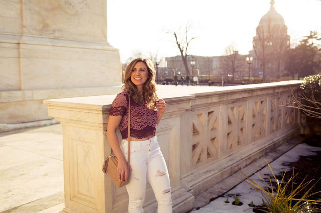 Lifestyle Blogger Roxanne of Glass of Glam wearing blush sneakers and a lace crop top