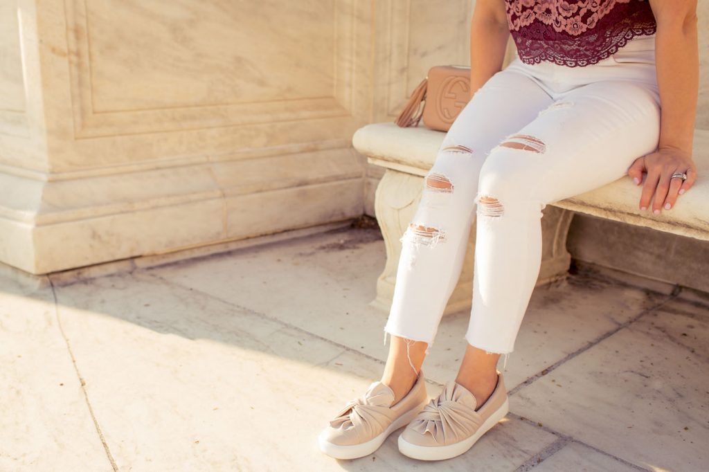 Lifestyle Blogger Roxanne of Glass of Glam wearing blush sneakers and a lace crop top