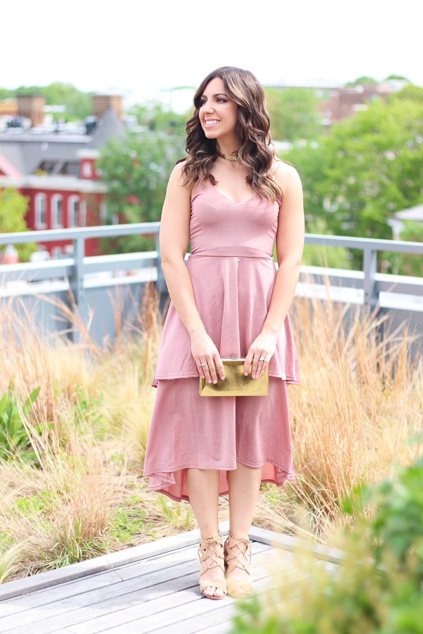 Lifestyle Blogger Roxanne of Glass of Glam wearing a blush Boohoo dress and gold box clutch