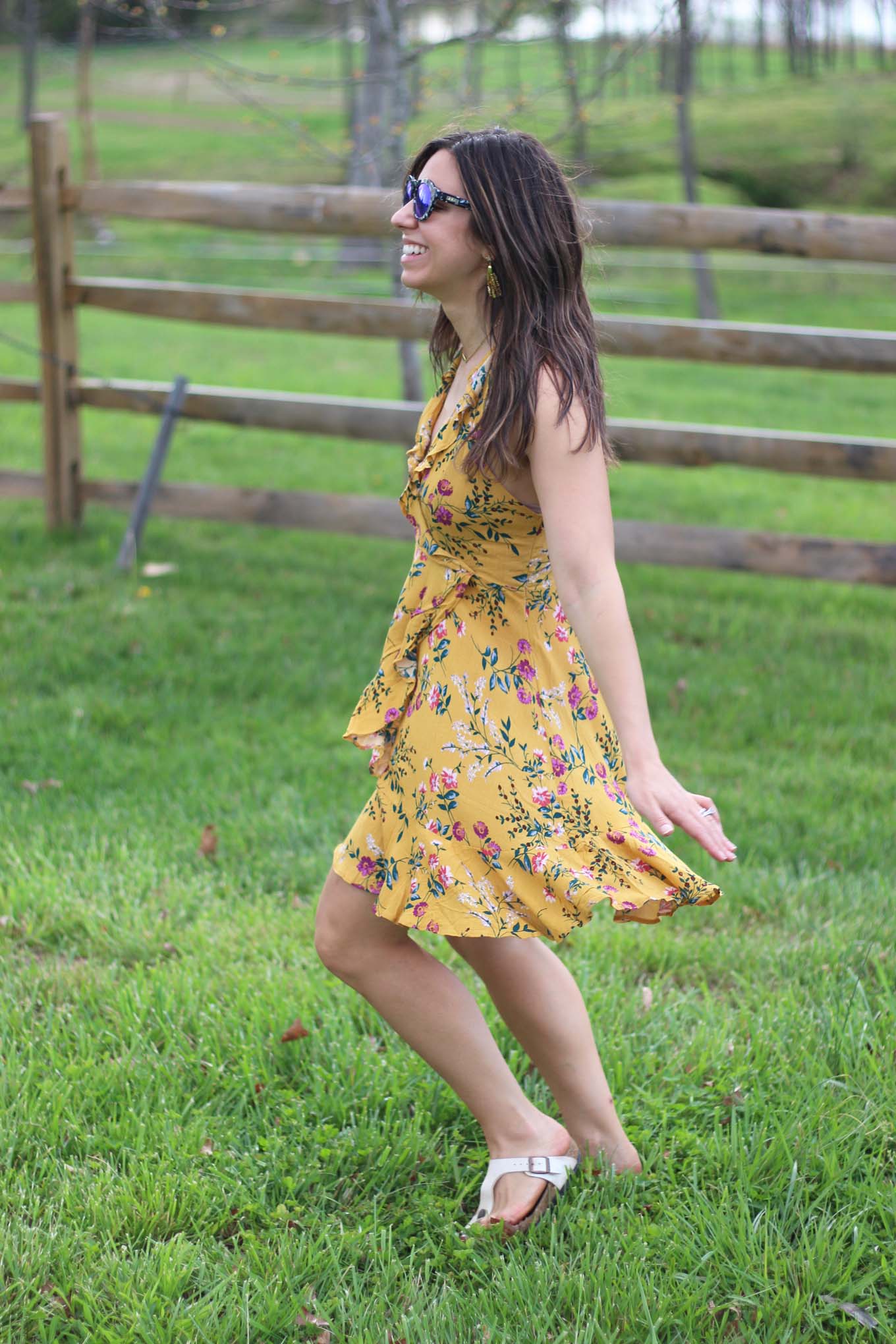 Lifestyle blogger Roxanne of Glass of Glam wearing a yellow floral zaful dress at Bull Run Winery