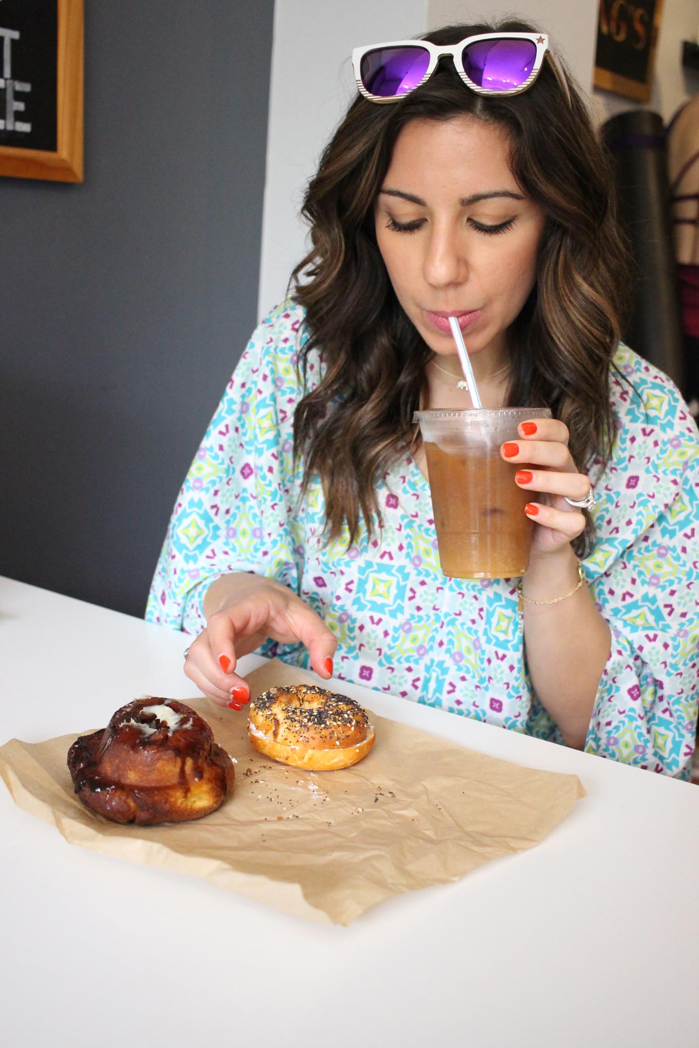 Lifestyle blogger Roxanne of Glass of Glam wearing a Cuddy Studios Romper, Winkwood Sunglasses, and her review of the 100% gluten free Rise Bakery