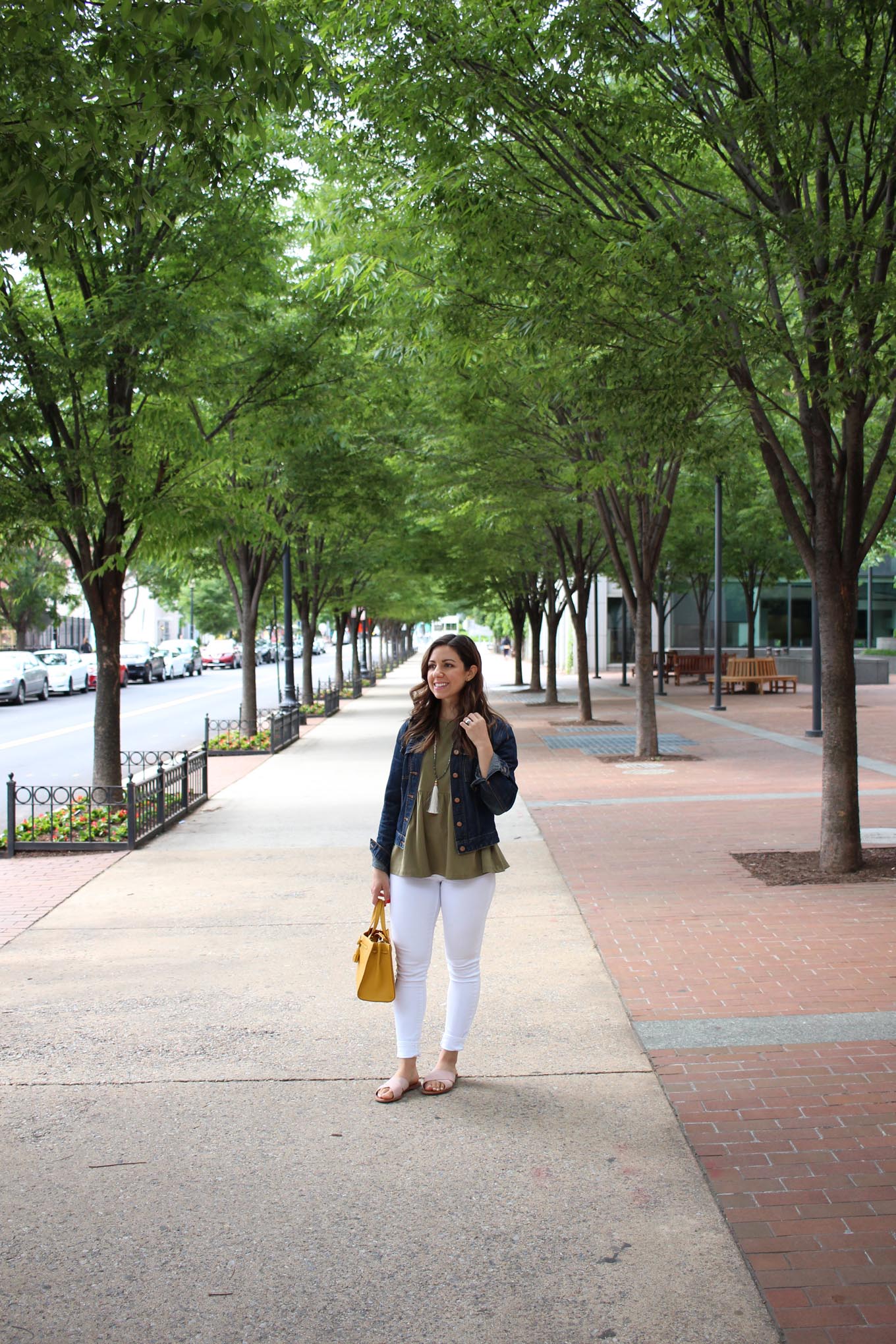 Lifestyle Blogger Roxanne of Glass of Glam wearing an army green peplum top, white denim, kate spade bag, and pink slides