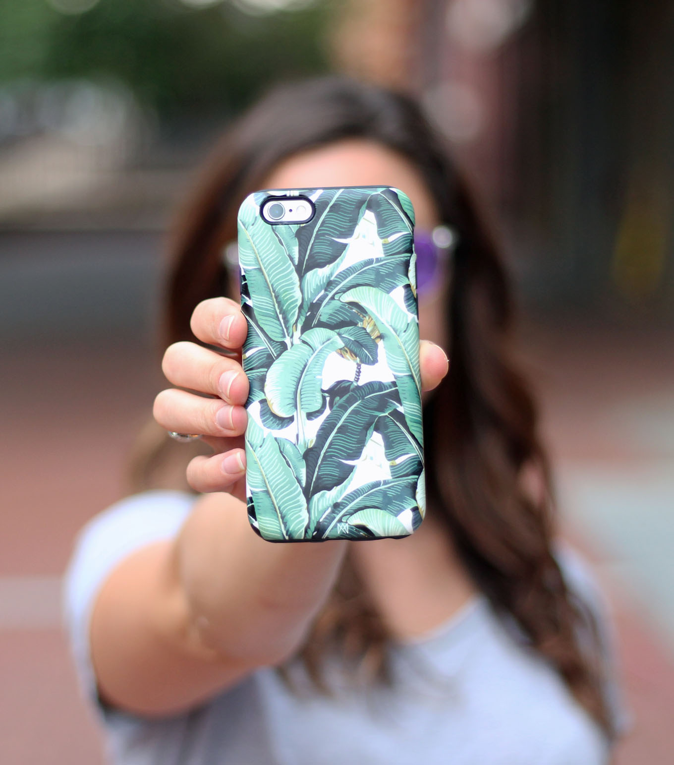 Lifestyle blogger Roxanne of Glass of Glam's tropical palm print macbook skin and phone skin from Caseapp