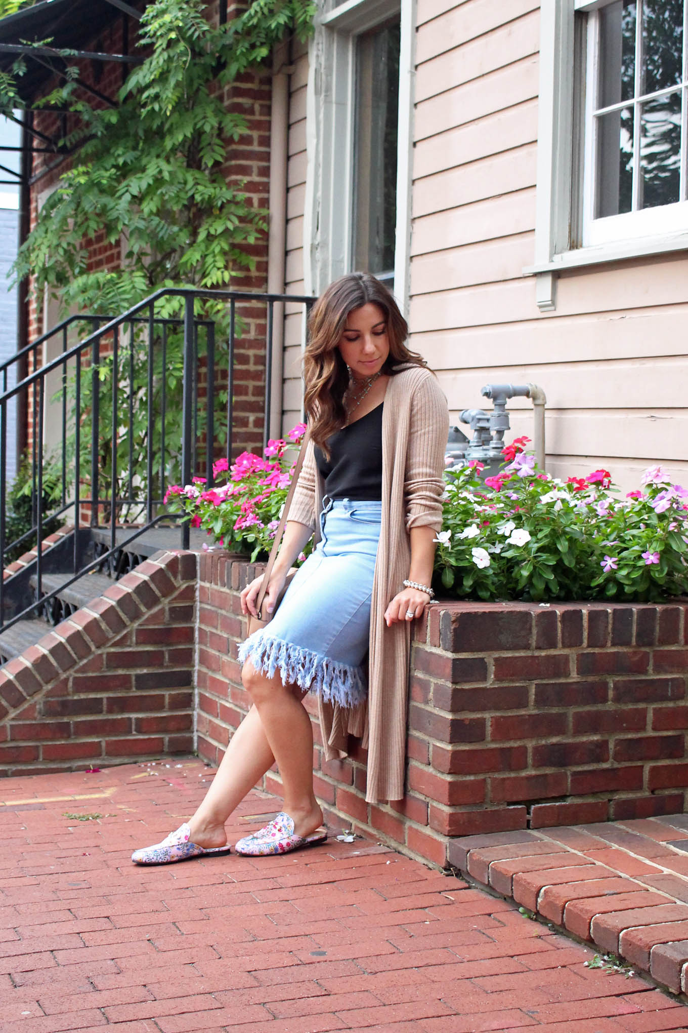 Lifestyle blogger Roxanne of Glass of Glam wearing a Justfab duster cardigan, distressed denim skirt, and pink Gucci dupes