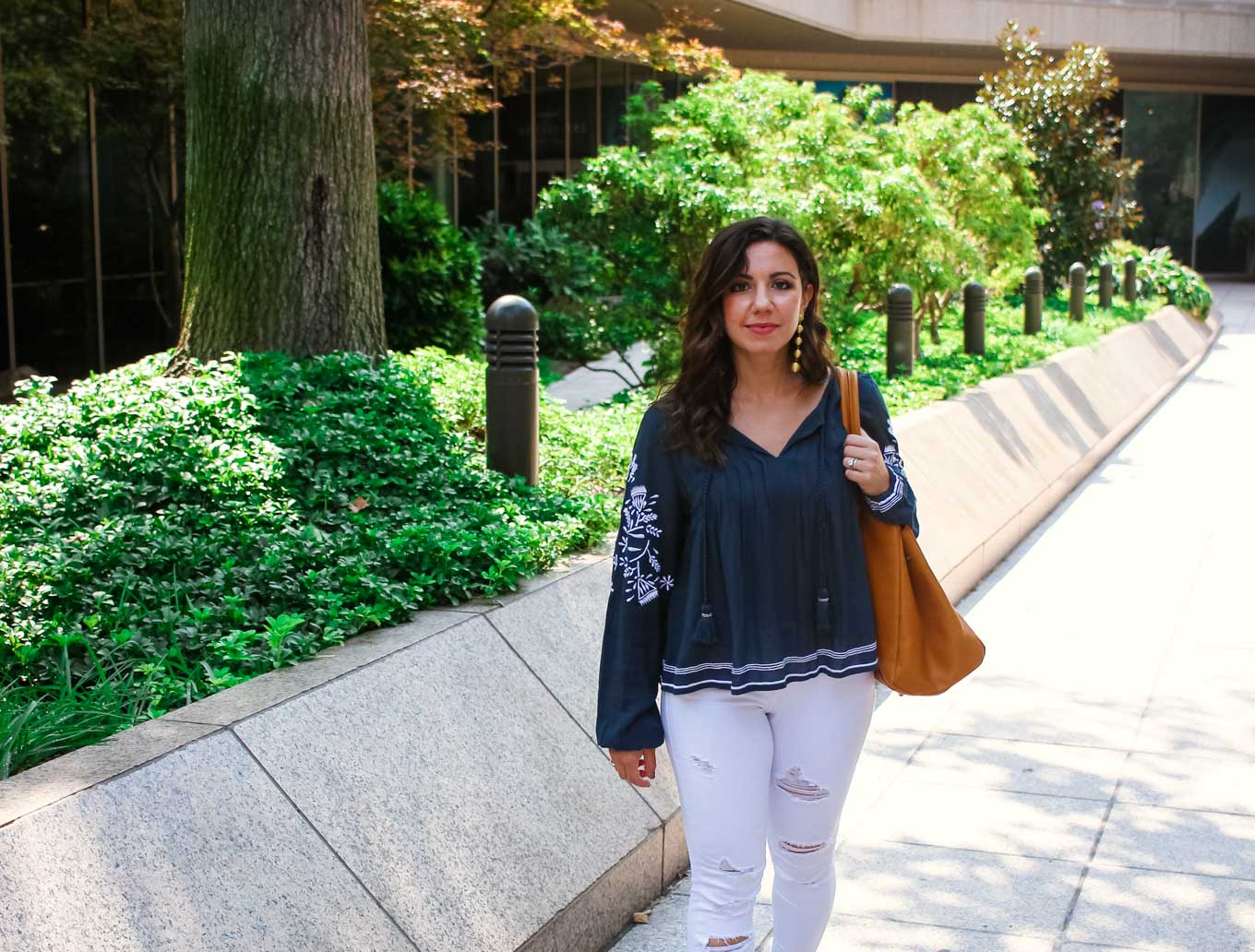 Lifestyle blogger Roxanne of Glass of Glam wearing a Tularosa blouse, Old Navy denim, 2Rivers tote, and Baublebar Earrings