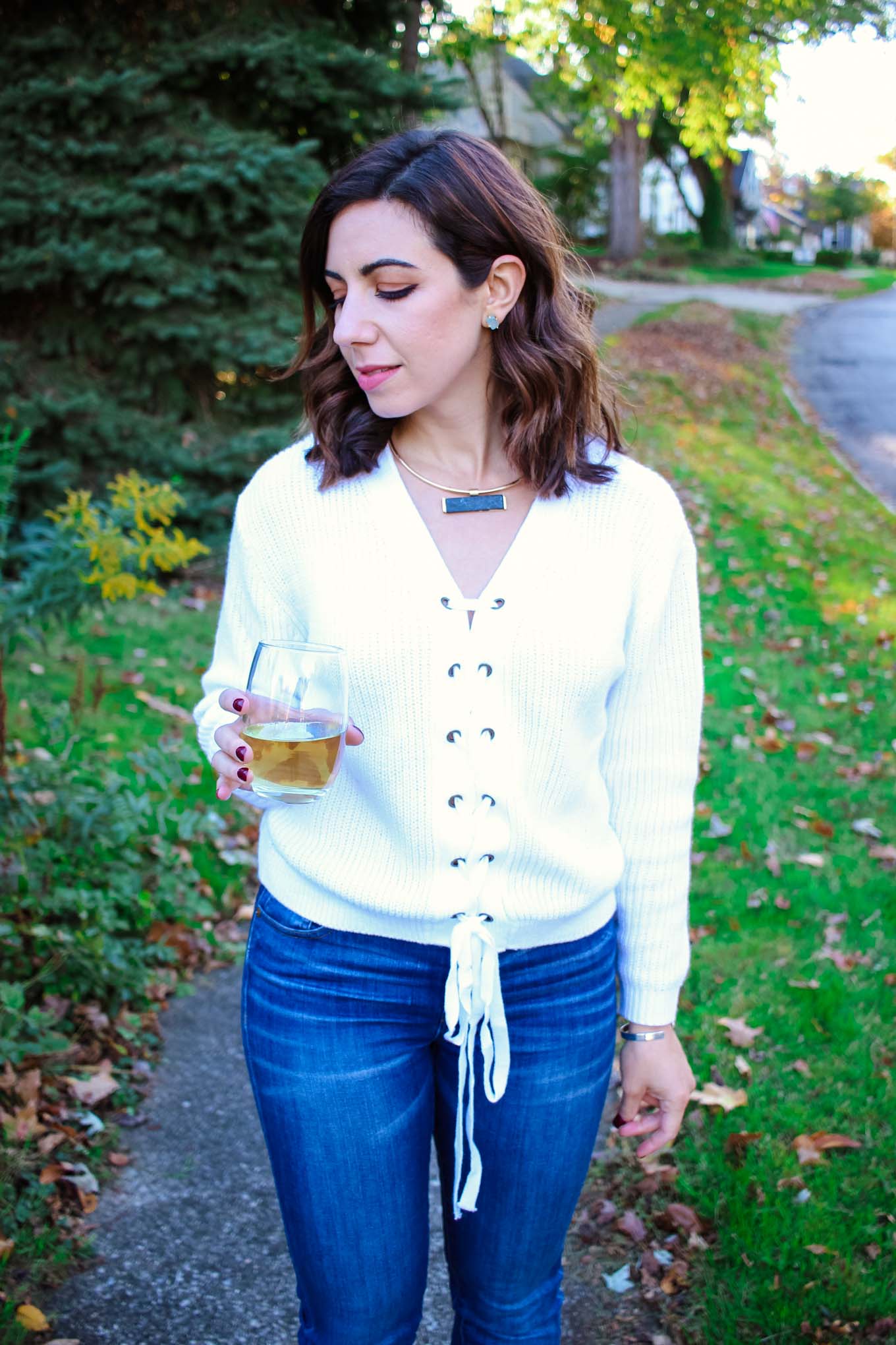 Lifestyle blogger Roxanne of Glass of Glam wearing a lace up sweater, A Gold E denim, Vince Camuto booties, and a T&J Designs Necklace - Baseball Sweater by popular DC fashion blogger Glass of Glam
