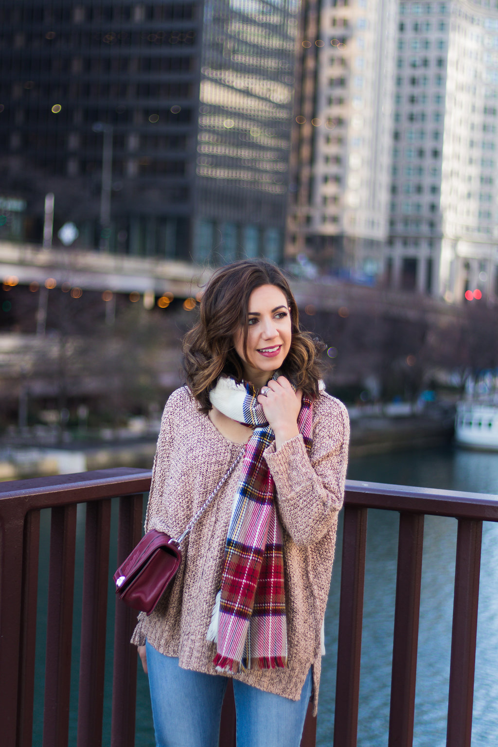 lifestyle blogger Roxanne of Glass of Glam wearing a Gray Monroe sweater, plaid scarf, Rebecca Minkoff bag, Madewell denim, and red slouch boots