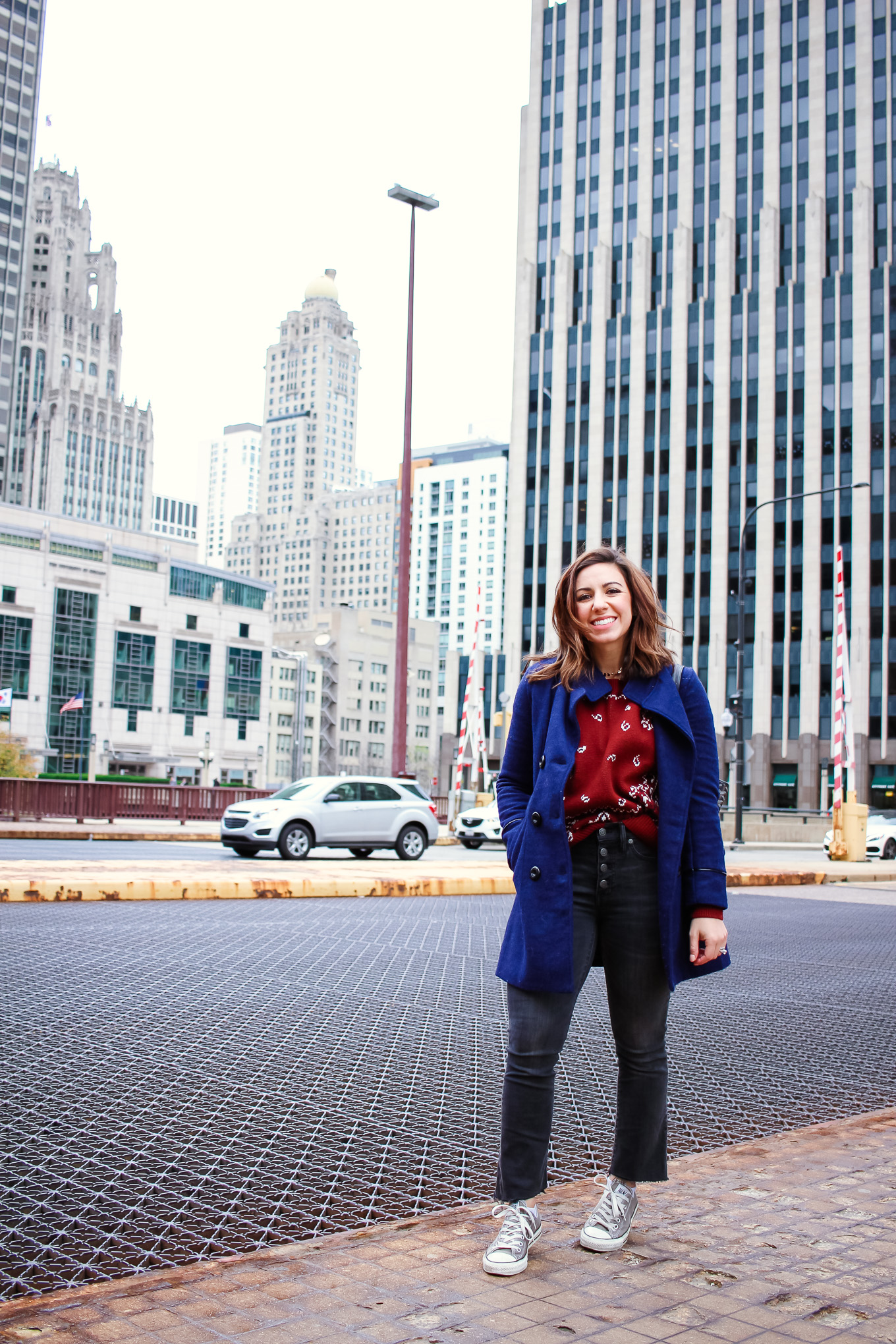 Lifestyle blogger Roxanne of Glass of Glam wearing a Madewell cropped denim, Madewell sweater, converse, a Goyard handbag, and a blue peacoat - Ain't No Party Like A Cropped Denim Party by popular Chicago fashion blogger Glass of Glam