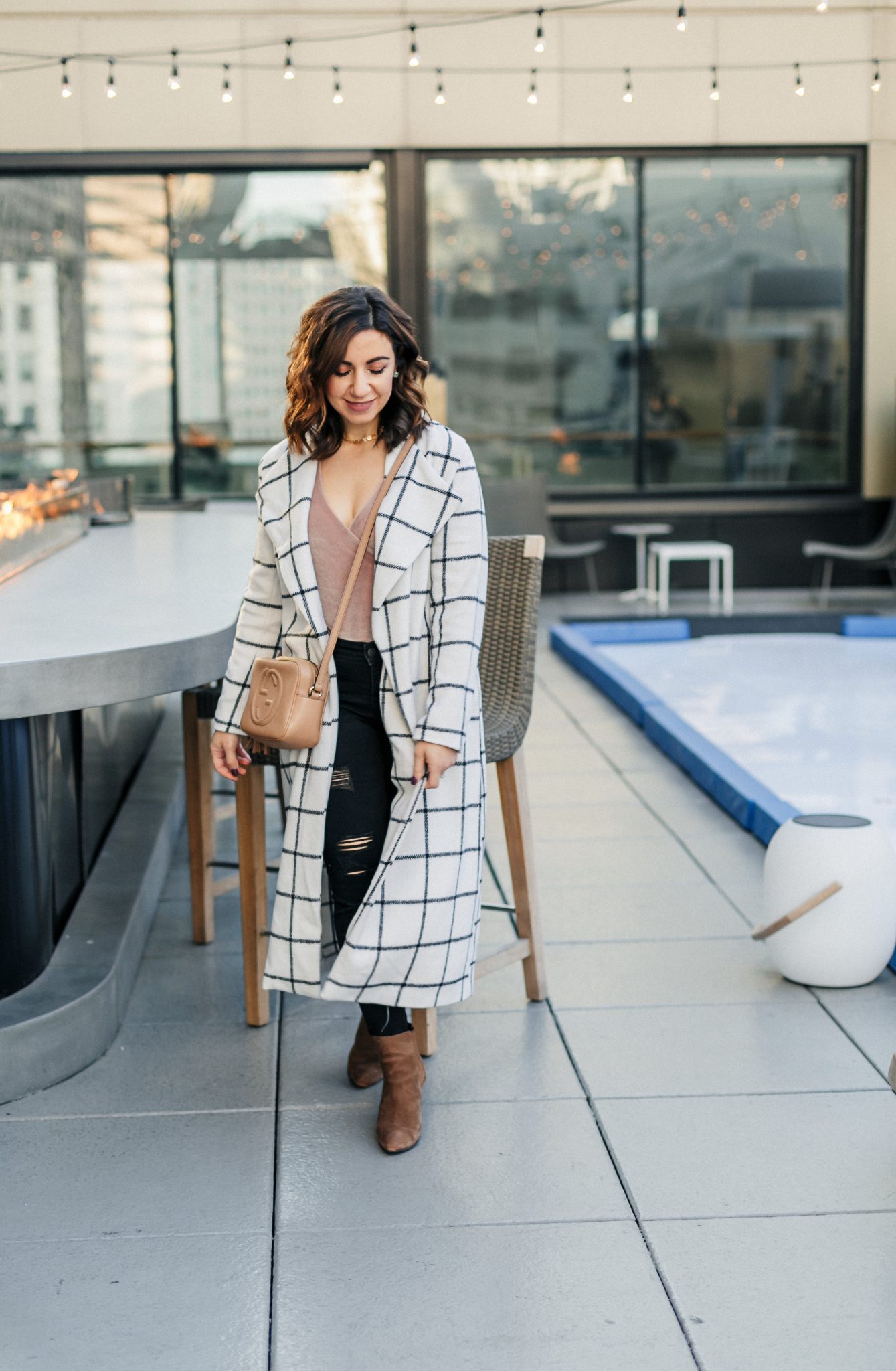 Lifestyle blogger Roxanne of Glass of Glam wearing a windowpane duster coat, velvet bodysuit, distressed denim, and a Gucci soho disco bag - SheIn windowpane duster coat by popular Washington fashion blogger Glass of Glam