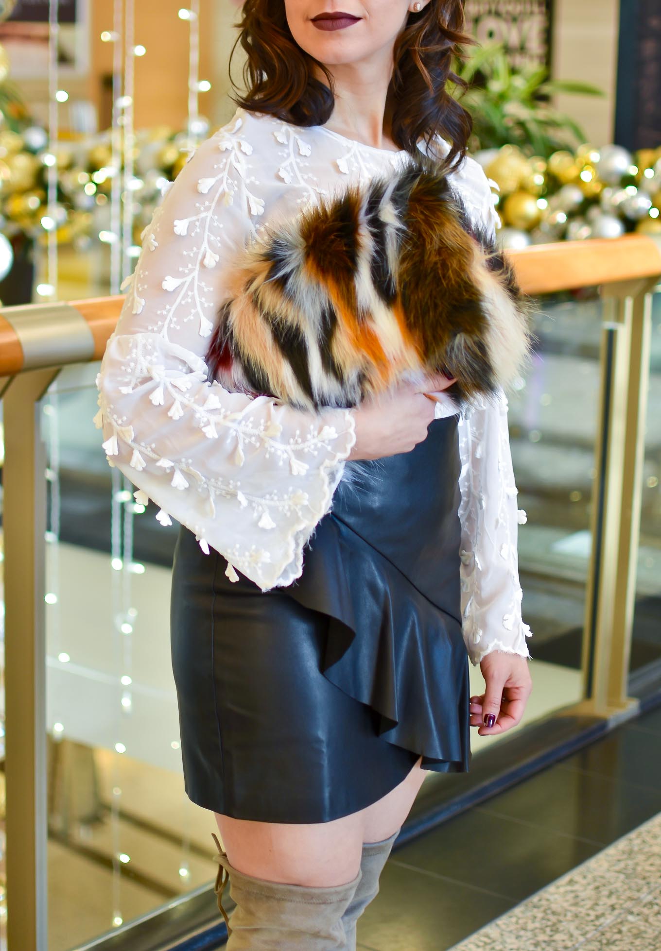 Lifestyle blogger Roxanne of Glass of Glam wearing a faux leather skirt, Shein embroidered blouse, faux fur clutch, and Steve Madden boots - Golden Birthday Wisdom by popular Chicago fashion blogger Glass of Glam