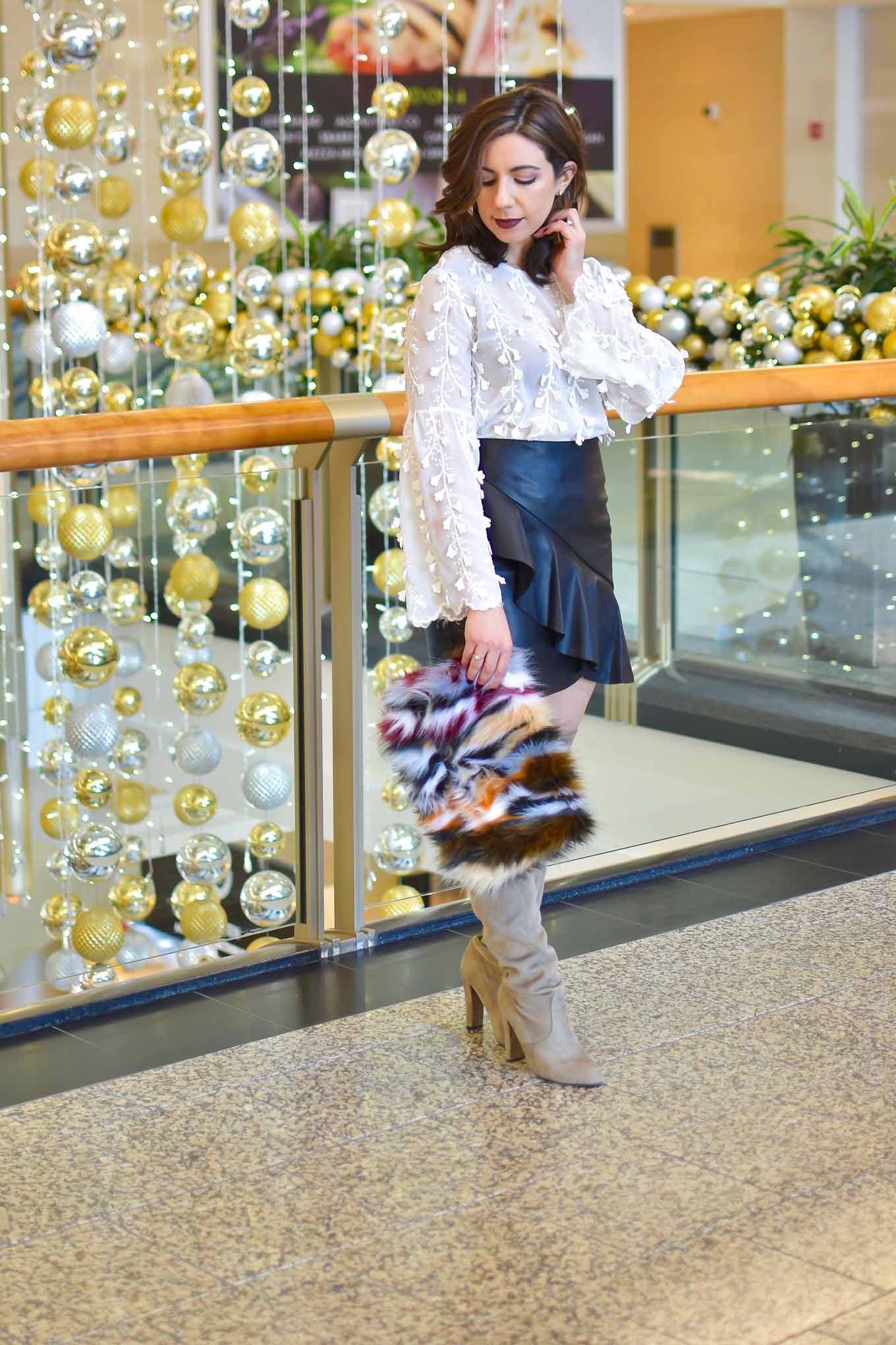 Lifestyle blogger Roxanne of Glass of Glam wearing a faux leather skirt, Shein embroidered blouse, faux fur clutch, and Steve Madden boots - Golden Birthday Wisdom by popular Chicago fashion blogger Glass of Glam