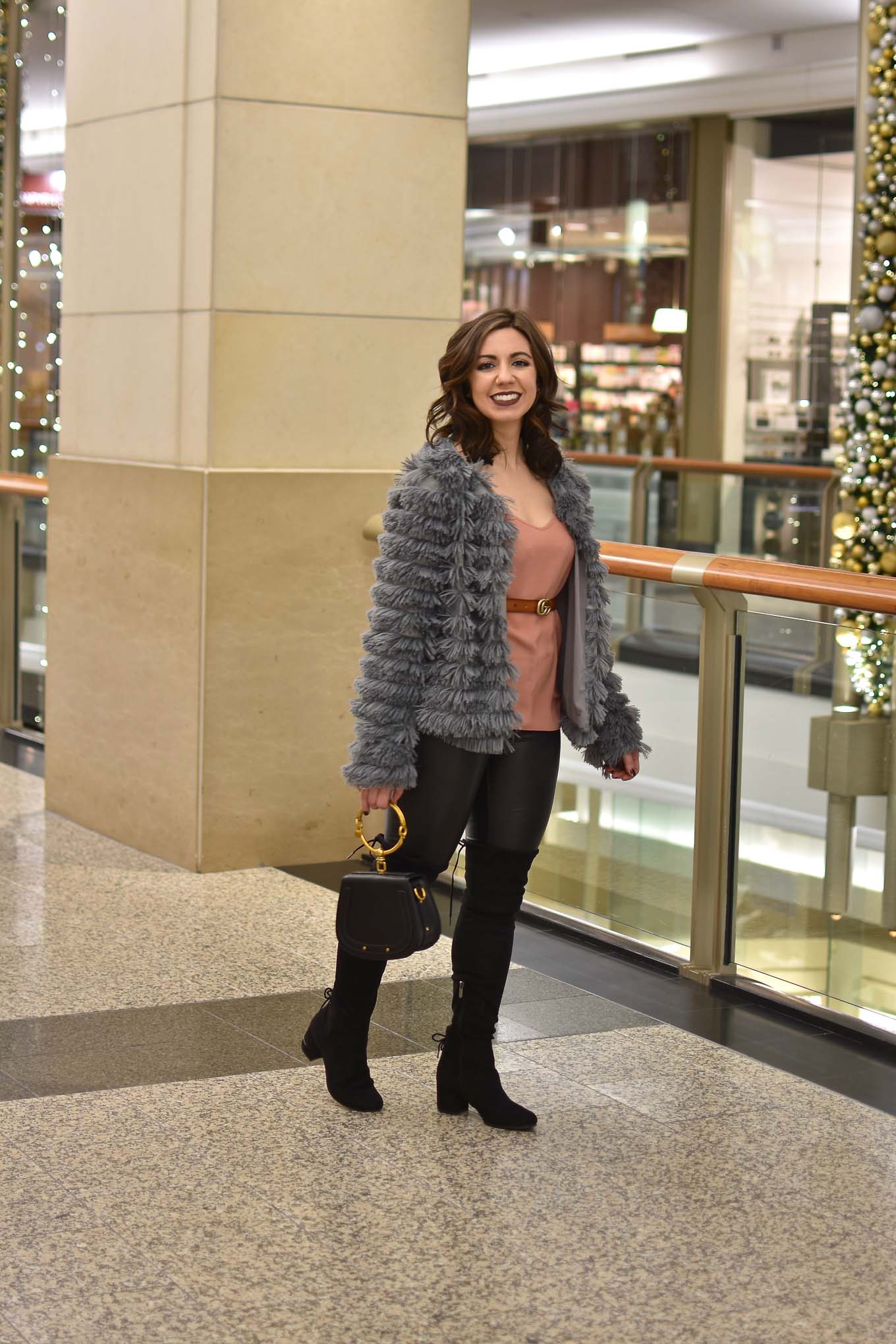 Lifestyle blogger Roxanne of Glass of Glam wearing an Amazon fashion faux fur jacket, faux leather leggings, Chloe Nile bag, otk boots, and Gerard Cosmetics lipstick - Faux Leather leggings by popular Chicago fashion blogger Glass of Glam