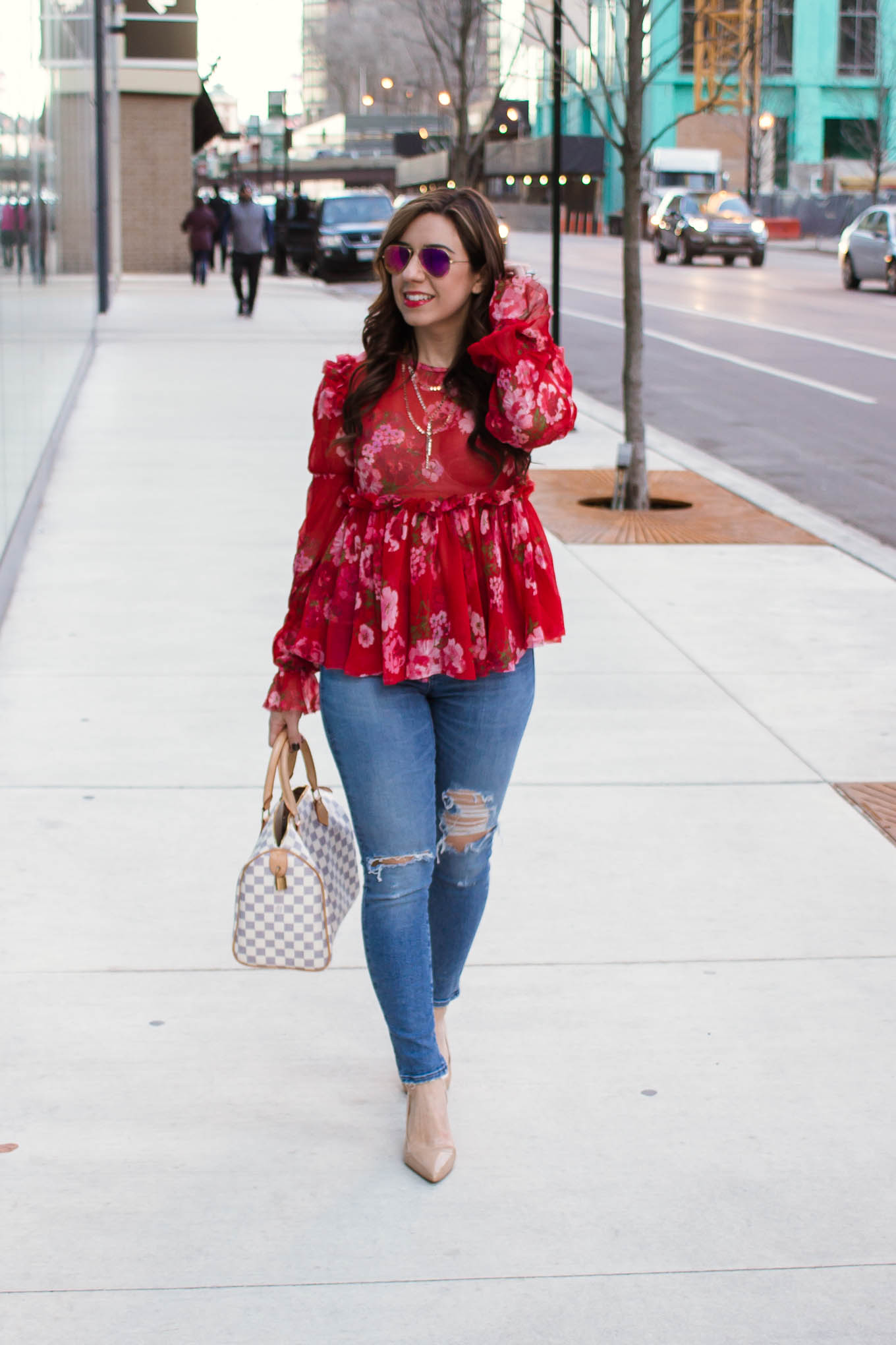 Lifestyle blogger Roxanne of Glass of Glam wearing an Asos ruffle top, Agolde denim, and Sam Edelman pumps