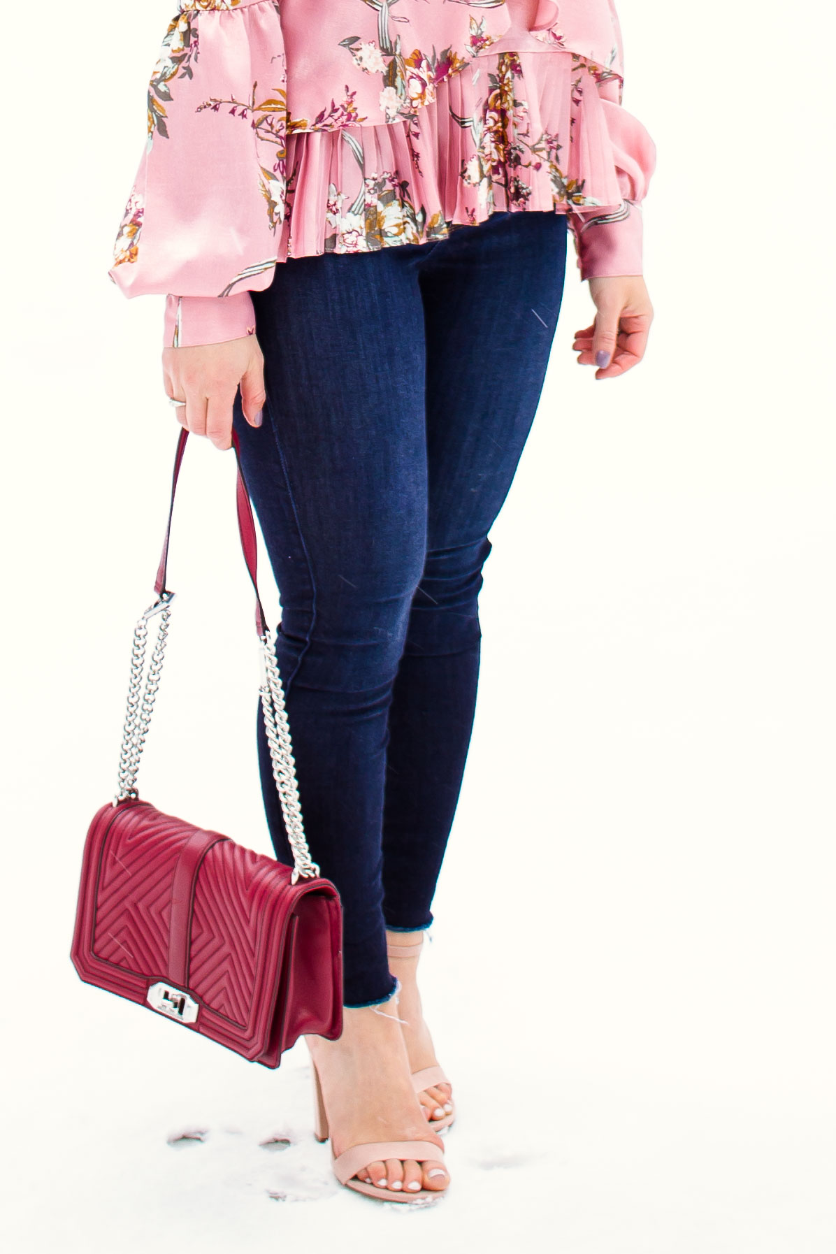 Valentines Day Outfit styled by top US fashion blog, Glass of Glam: image of a woman wearing a Leith floral top, Mott and Bow skinny jeans, JustFab heels, and a Rebecca Minkoff crossbody bag