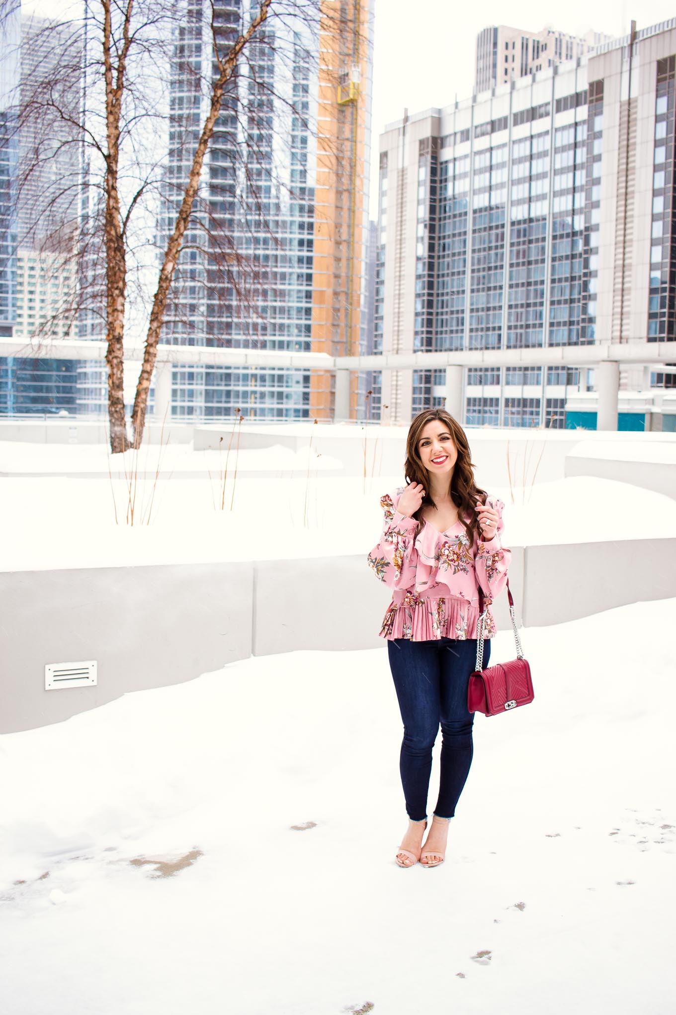 Valentines Day Outfit styled by top US fashion blog, Glass of Glam: image of a woman wearing a Leith floral top, Mott and Bow skinny jeans, JustFab heels, and a Rebecca Minkoff crossbody bag