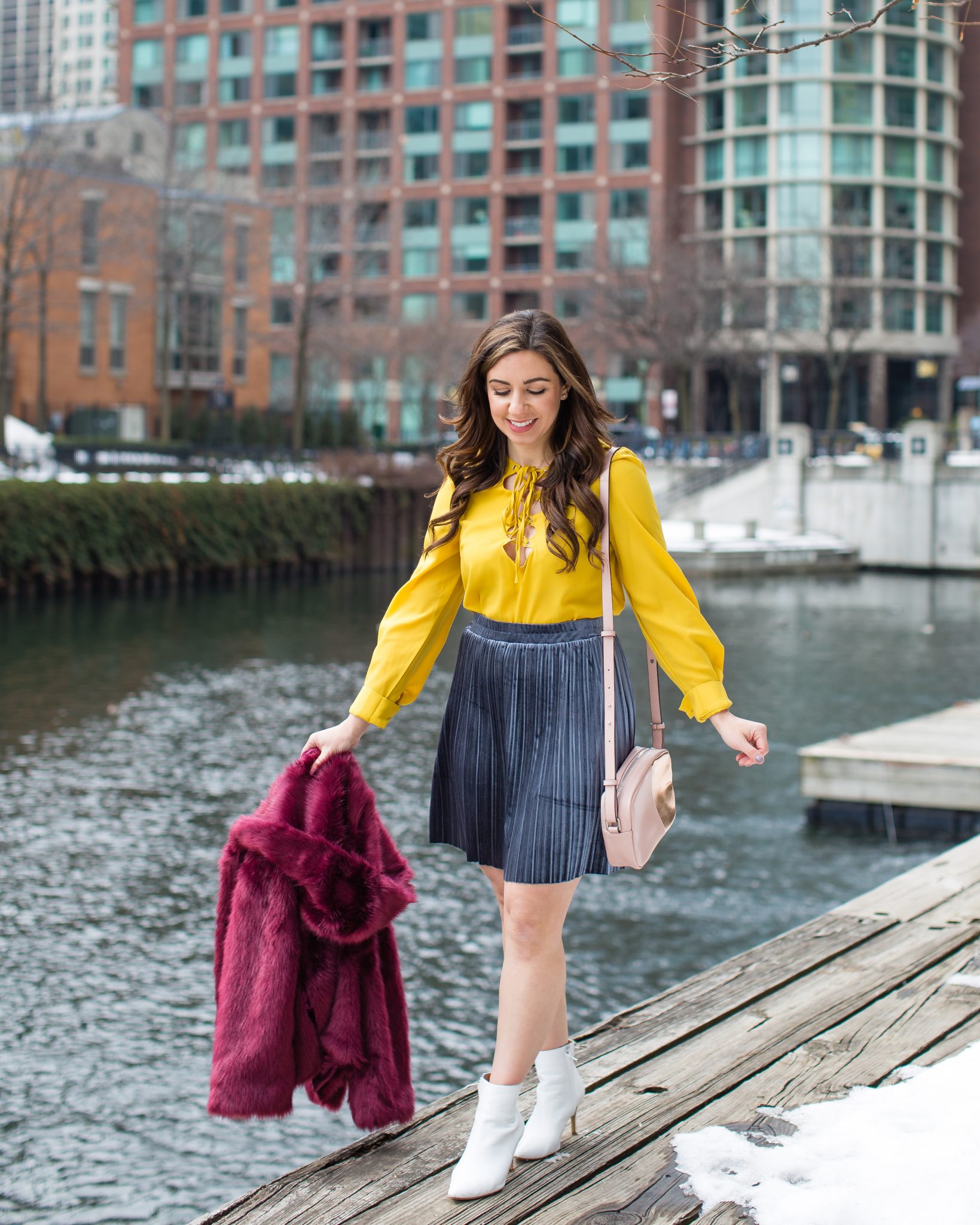 Lifestyle blogger Roxanne of Glass of Glam wearing a missguided faux fur coat, Shein mustard top, Asos velvet skirt, and white booties - A primary colors outfit by popular Chicago fashion blogger Glass of Glam 