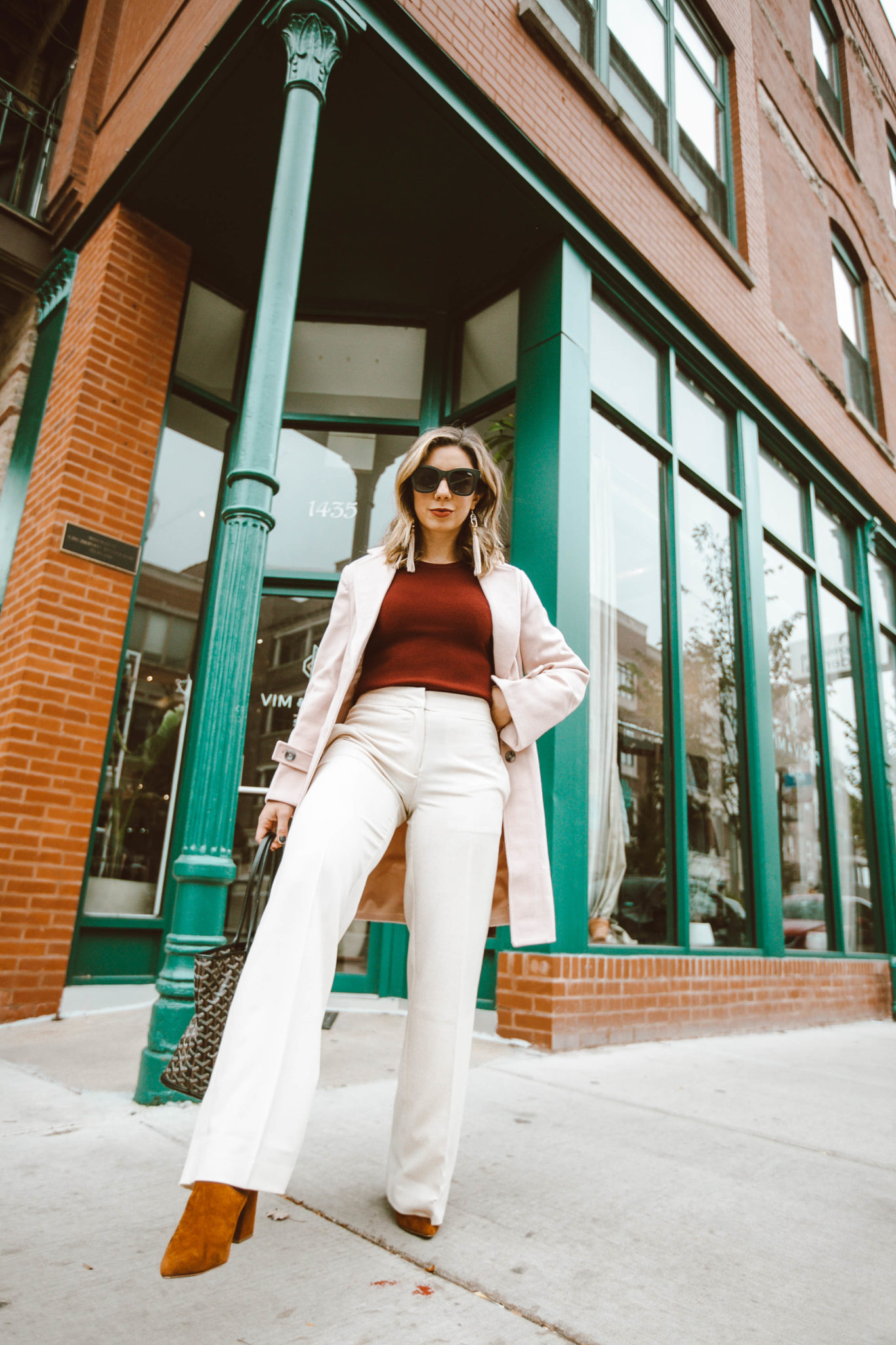 Trendy workwear featured by top Chicago fashion blog, Glass of Glam: picture of a woman wearing Chadwicks pants, Chadwicks coat and Chadwicks sweater, Steve Madden booties, Goyard bag and Quay sunglasses