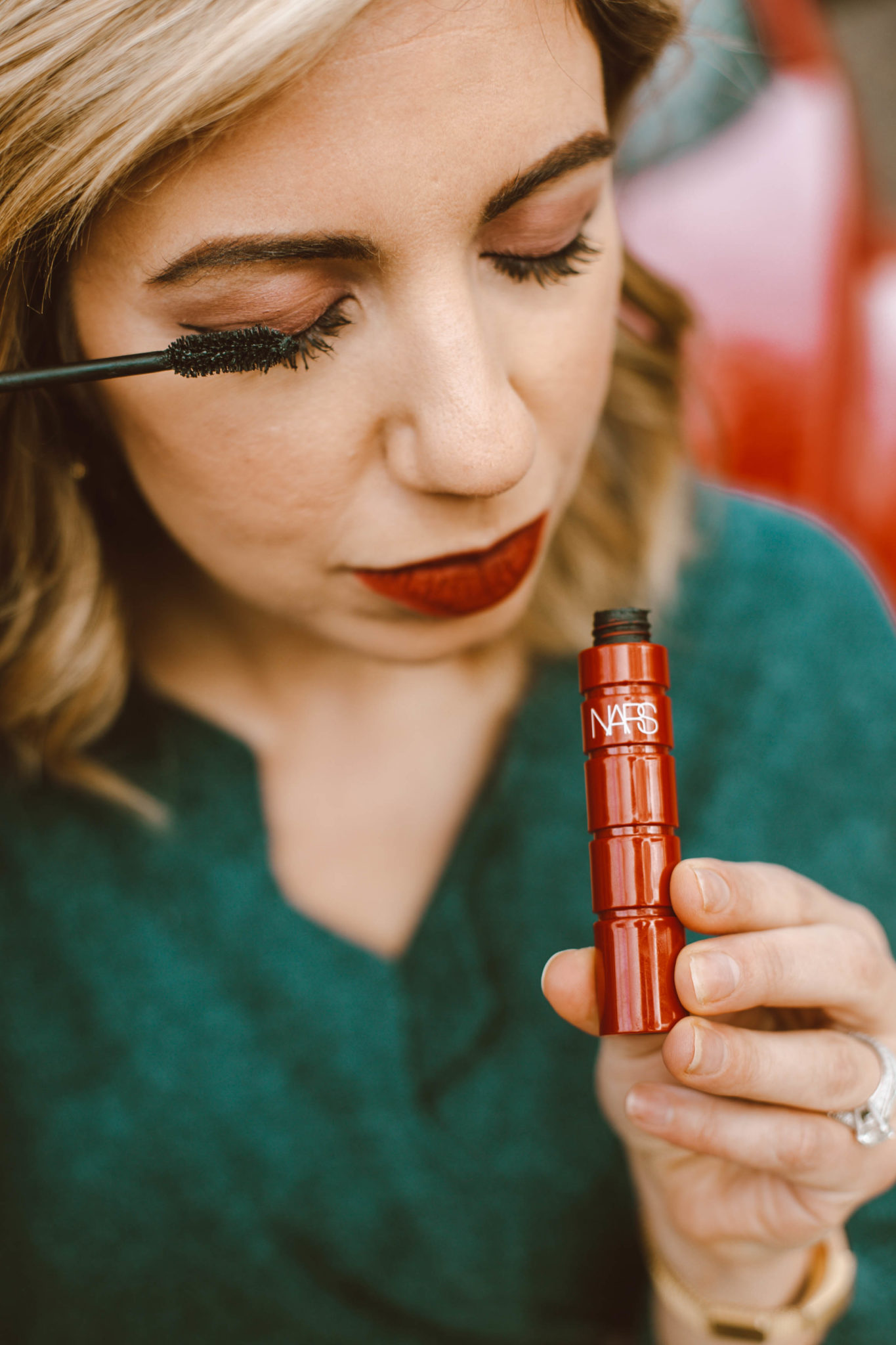 Beauty Gift Ideas featured by top Chicago beauty blog, Glass of Glam: image of a woman trying on NARS mascara