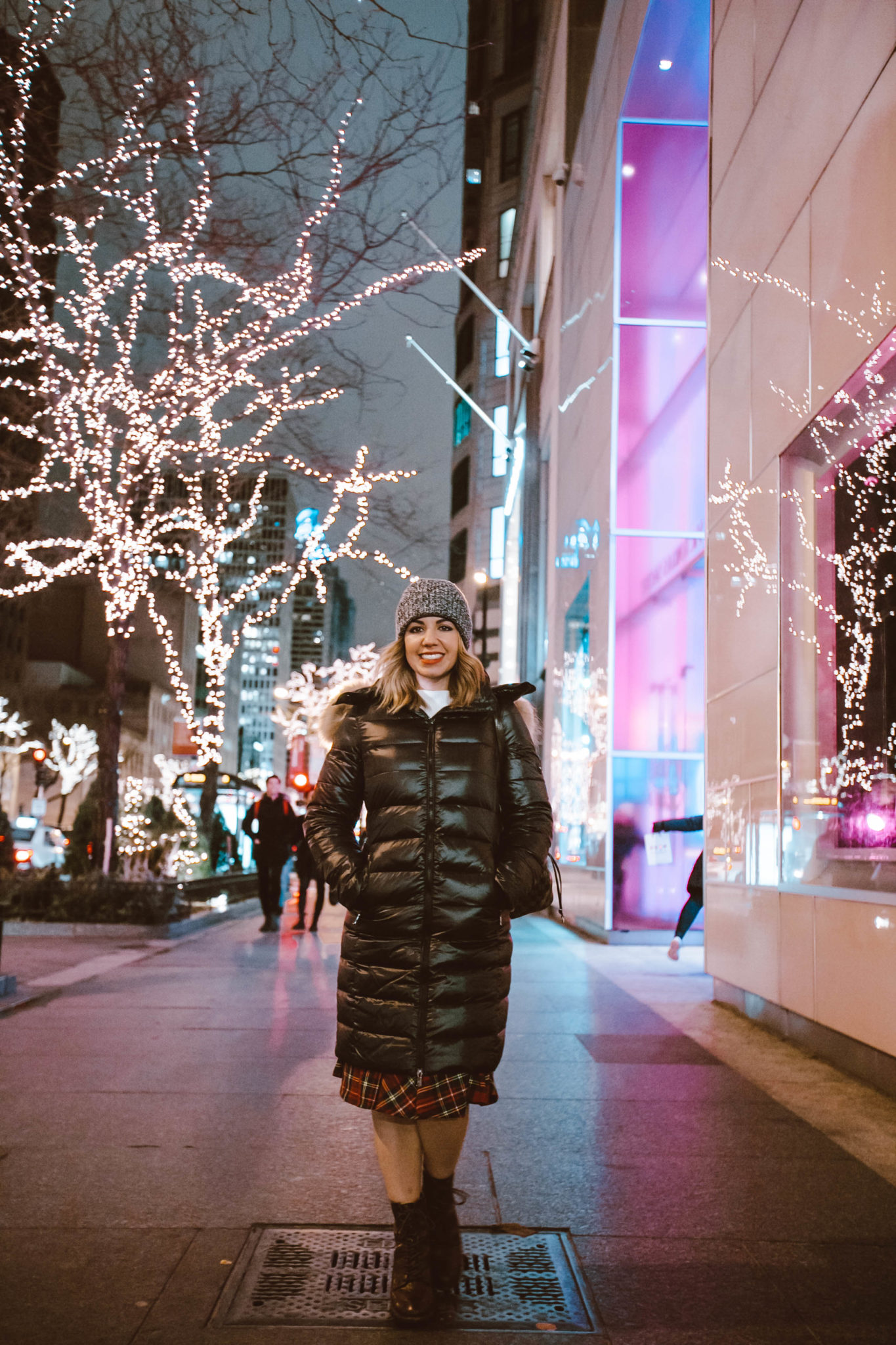 Best Chicago winter activities featured by top Chicago blog, Glass of Glam: picture of a woman in Chicago wearing a Happy Goat Lucky long puffer coat, Modcloth plaid skirt, Line & Dot sweater and Patricia Nash booties