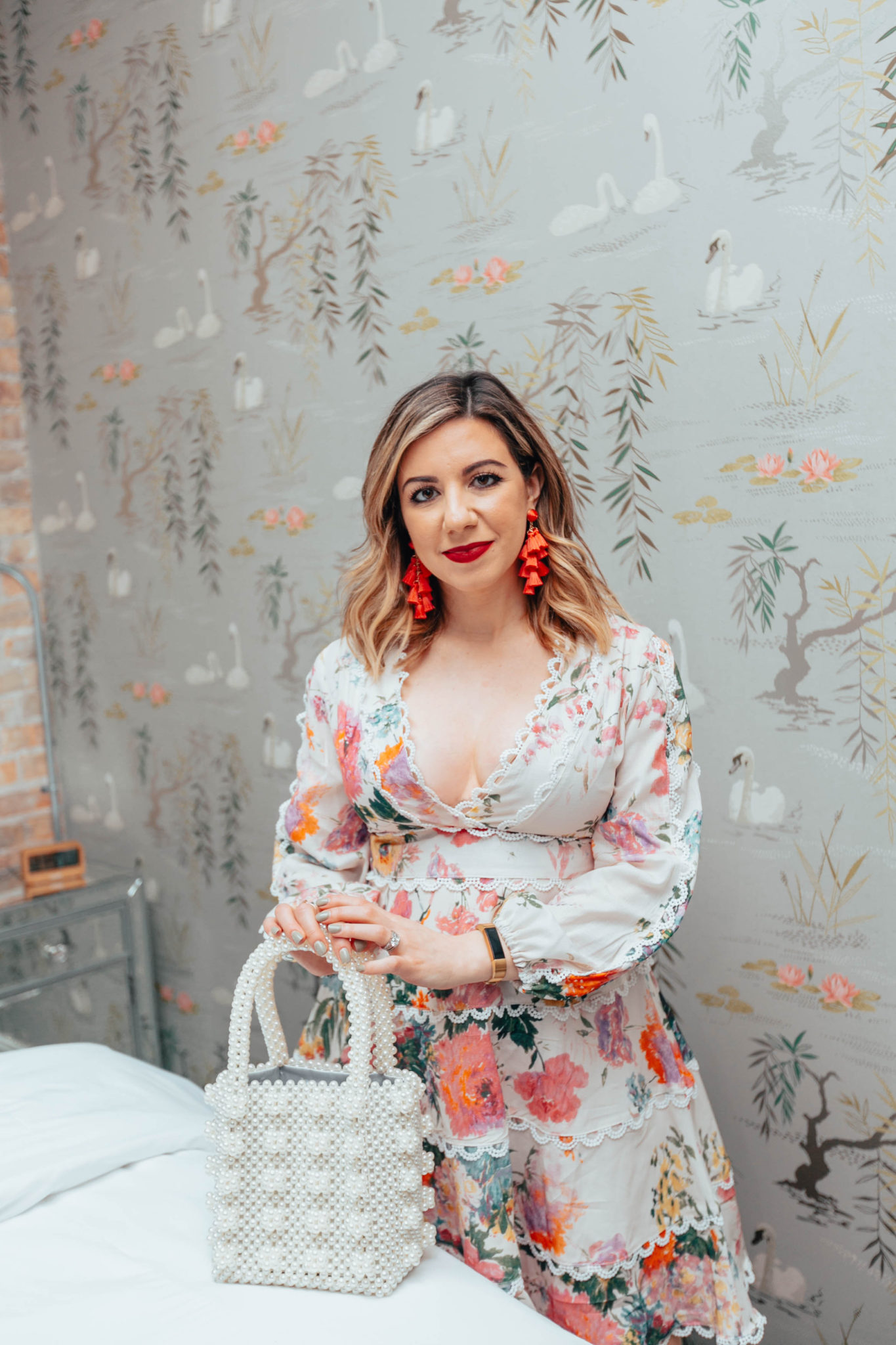 Top US life and style blogger, Glass of Glam, is now halfway through her pregnancy: image of a pregnant woman wearing a Chicwish floral dress, Naturalizer pumps, Mioco beaded bag and Sugarfix statement earrings