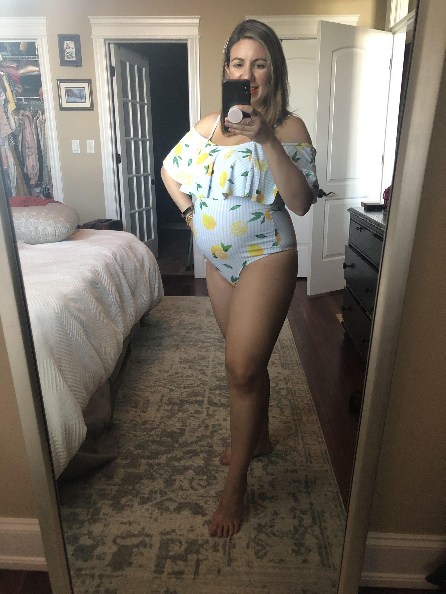 Summer maternity-friendly Shein clothing featured by top US fashion blog, Glass of Glam: image of a pregnant woman wearing a SheIn lemon one piece swimsuit