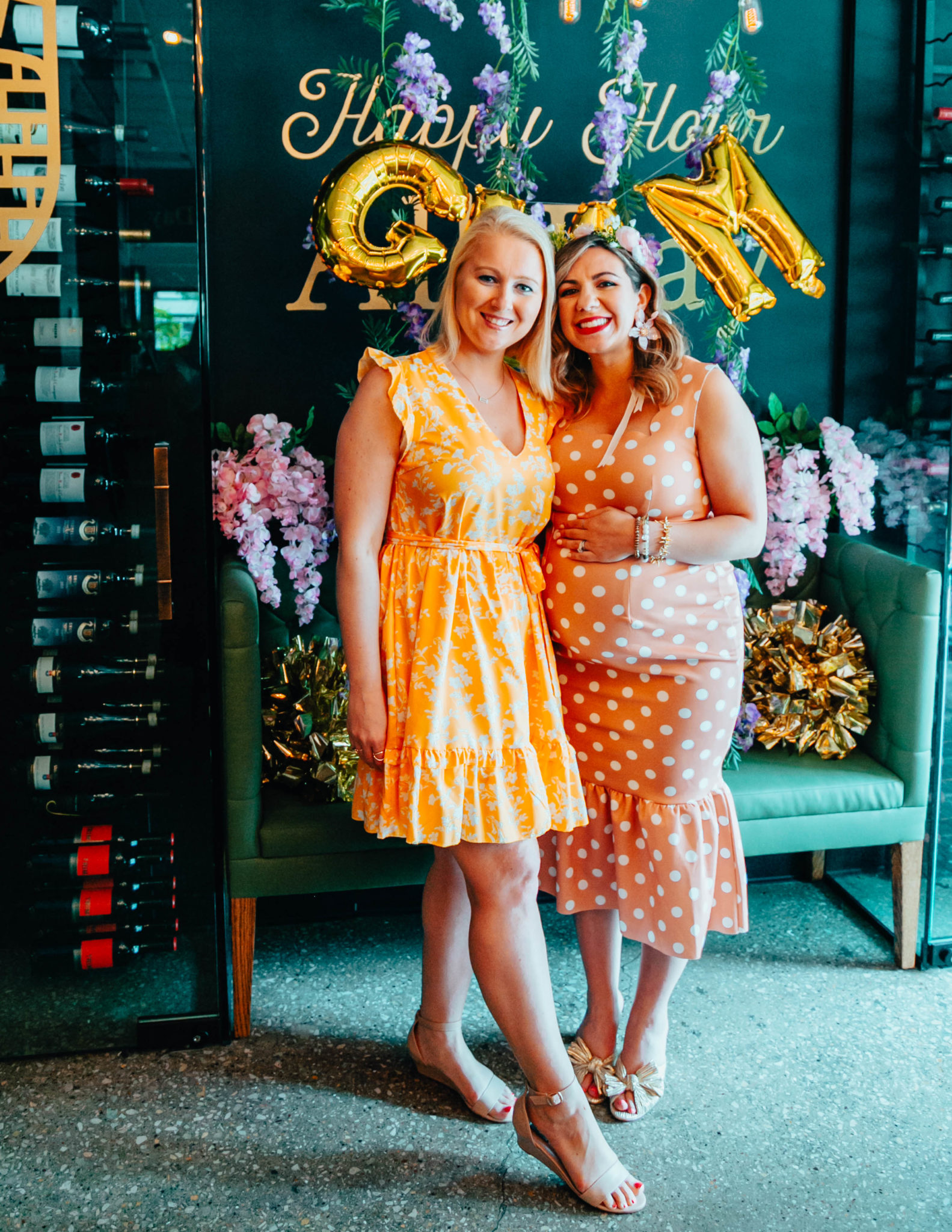 Baby Shower outfit featured by top US fashion blog, Glass of Glam: image of a pregnant woman attending her baby shower wearing an ASOS polka dot maternity dress, Loeffler Randall sandals, and Big Flower statement earrings.
