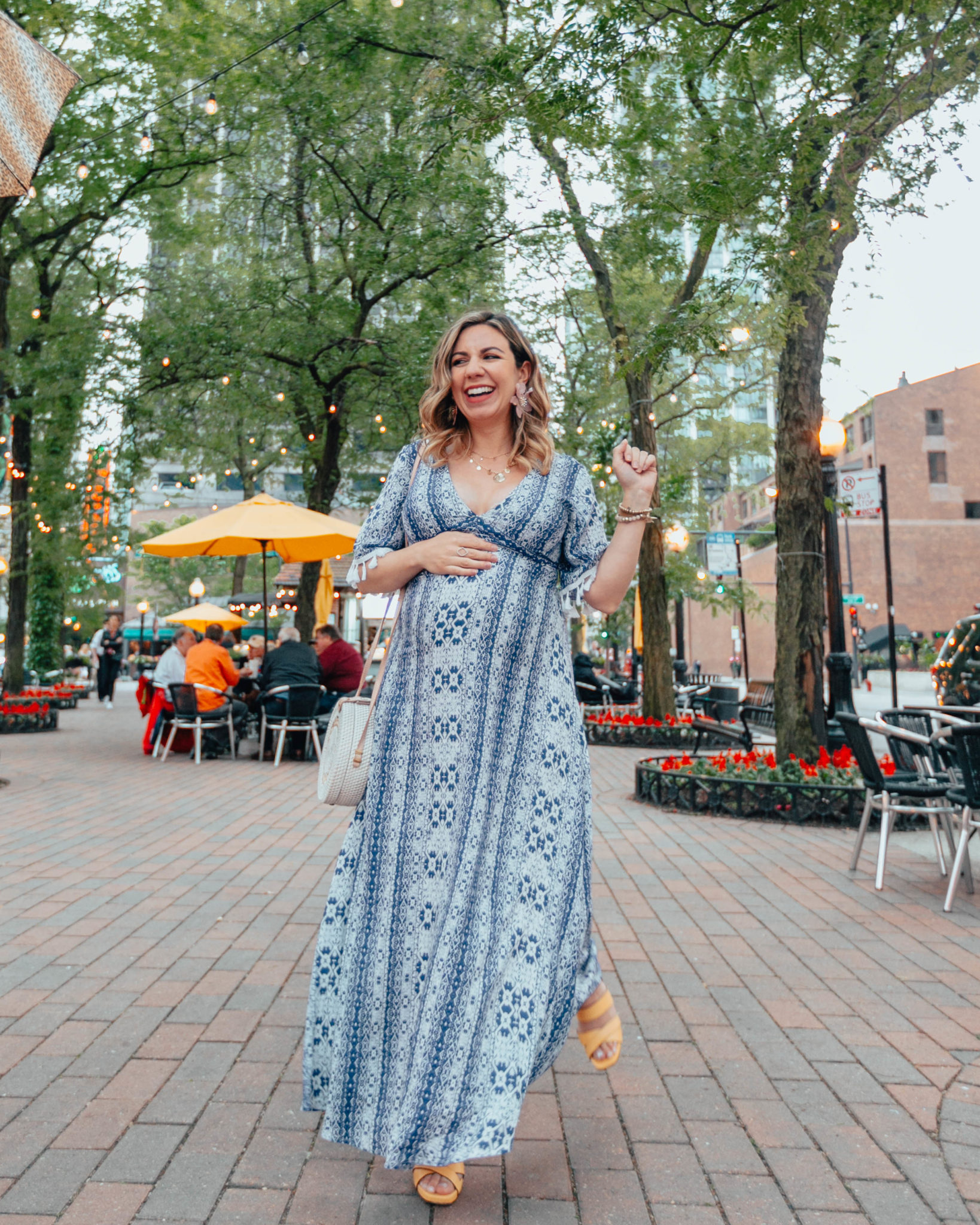 Naturalizer sandals on sale featured by top US fashion blog, Glass of Glam: image of a pregnant woman wearing a SheIn tassel maxi dress, big flower statement earrings, and Naturalizer yellow heel sandals