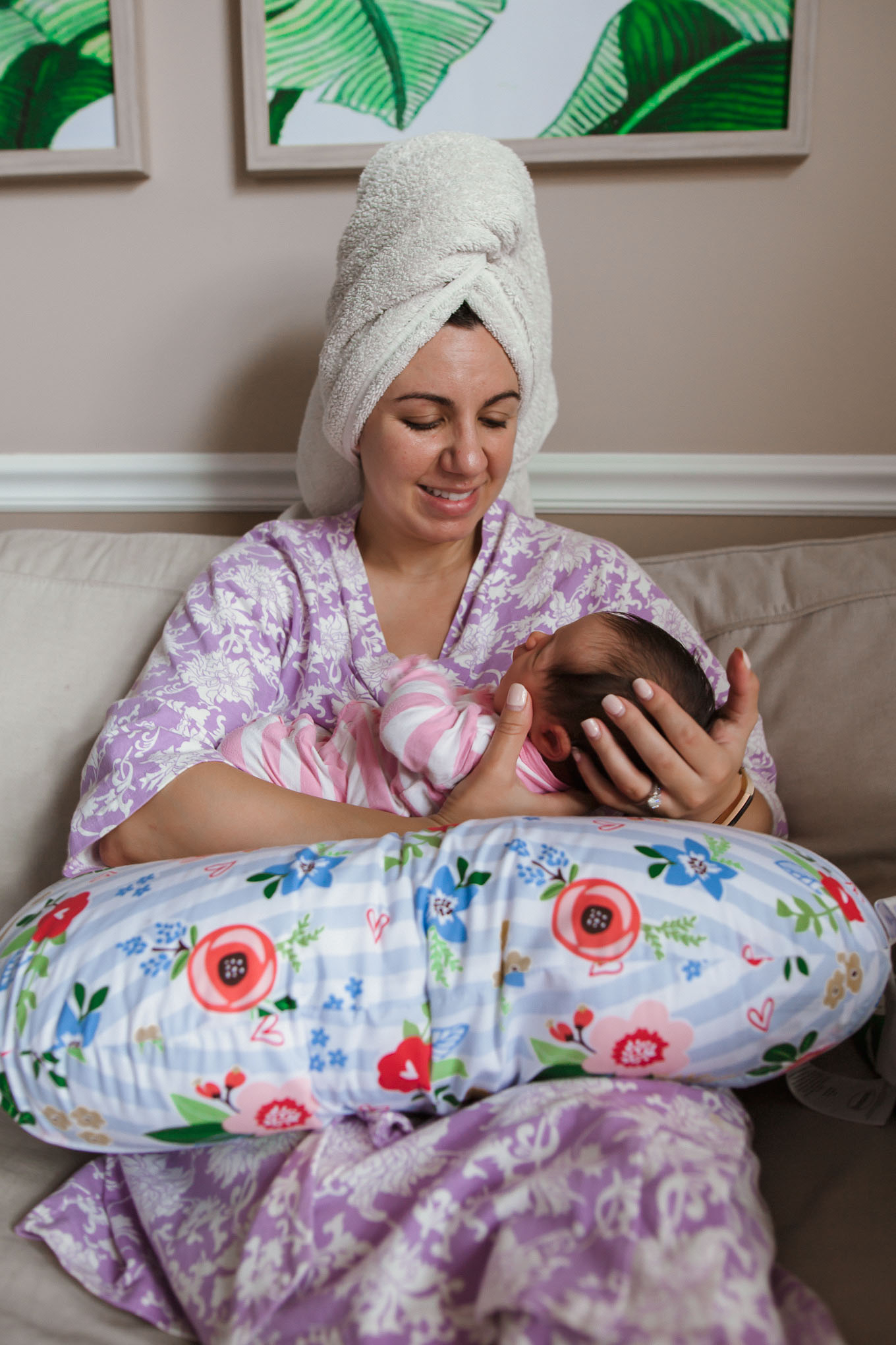 My 10 Breastfeeding Essentials by popular mommy blog, Glass of Glam: image of a woman wearing a purple and white floral robe and holding her baby on a Boppy Pillow.