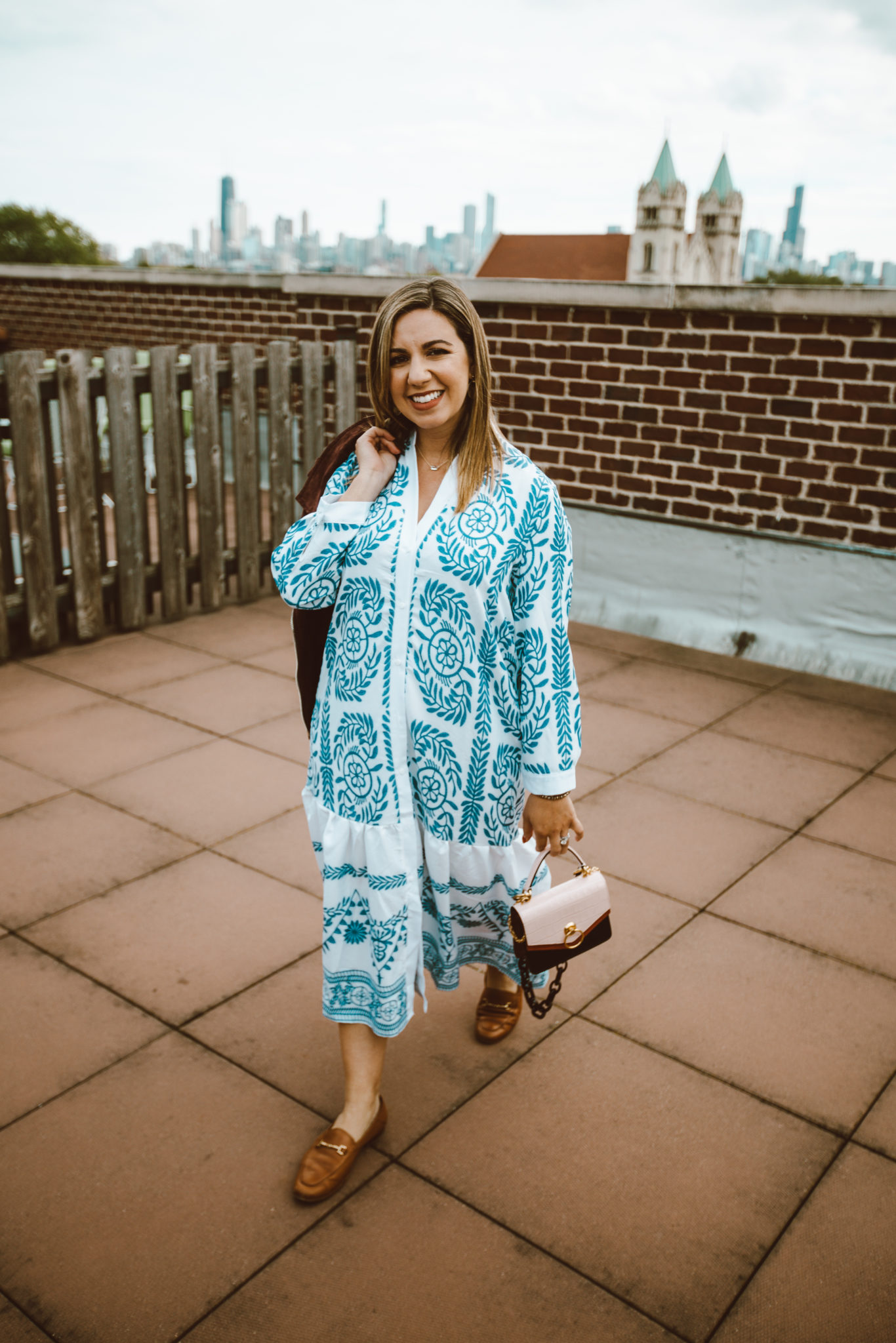 Giving Back With Kendra Scott Jewels by popular Chicago fashion blog, Glass of Glam: image of a woman outside wearing a SHEIN Tribal Print Shirt Dress, ShopBop Sam Edelman Loraine Loafers, Nordstrom BLANKNYC Suede Moto Jacket, Mulberry Small Harlow Satchel, Kendra Scott Deena Gold Earrings and Kendra Scott Ever Gold Pendant Necklace In Blush Dichroic Glass.