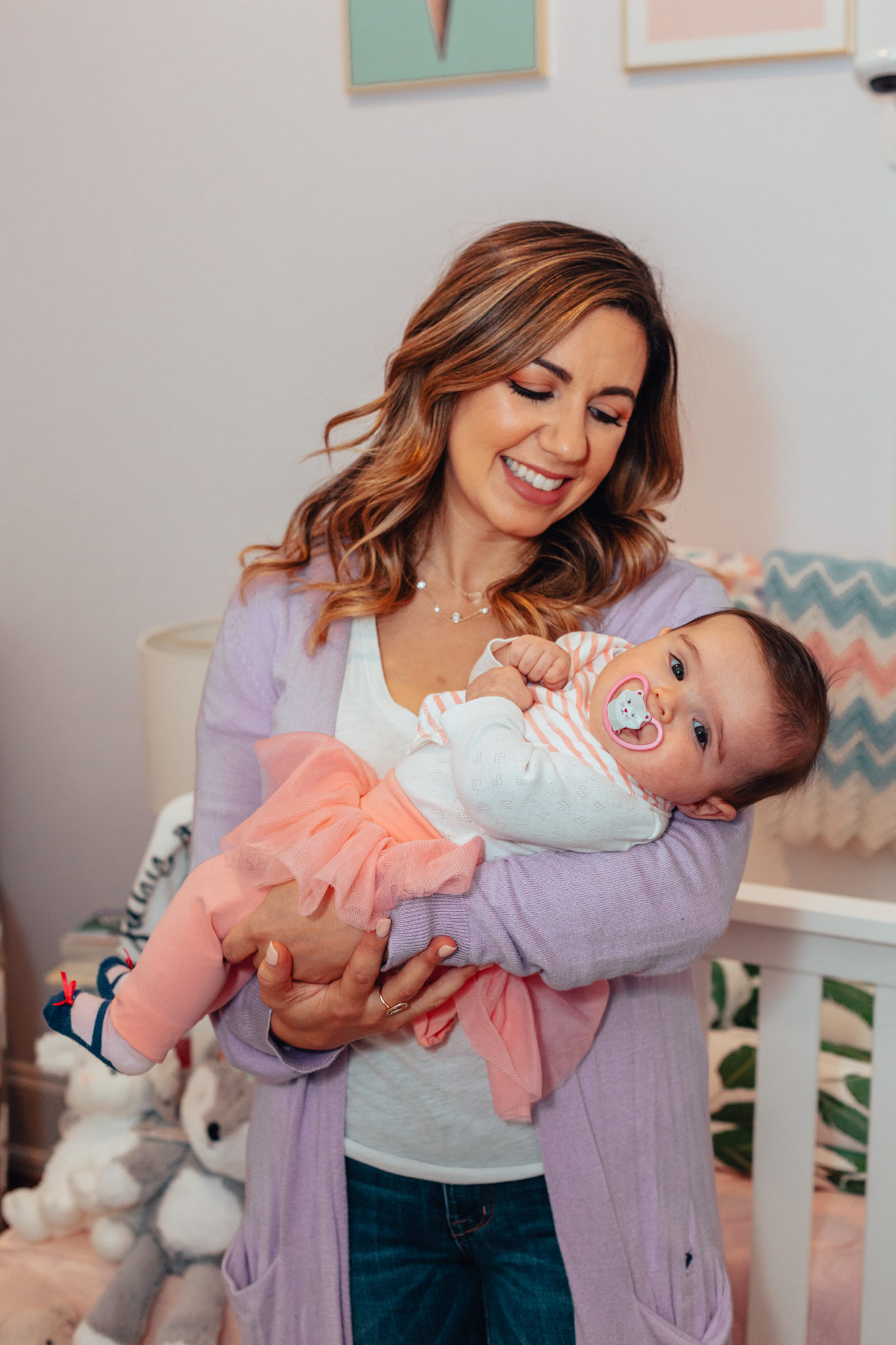 Amazing Gifts for New Moms by popular Chicago life and style blog, Glass of Glam: image of a mom holding a baby wearing a Gap Baby Tulle Skirt Legging Duo.