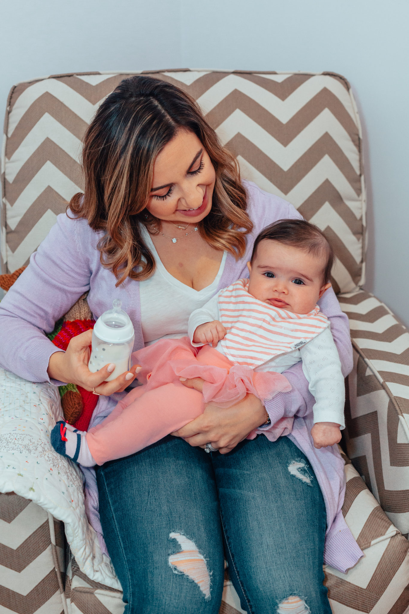 Amazing Gifts for New Moms by popular Chicago life and style blog, Glass of Glam: image of a mom holding a baby wearing a Gap Baby Tulle Skirt Legging Duo.
