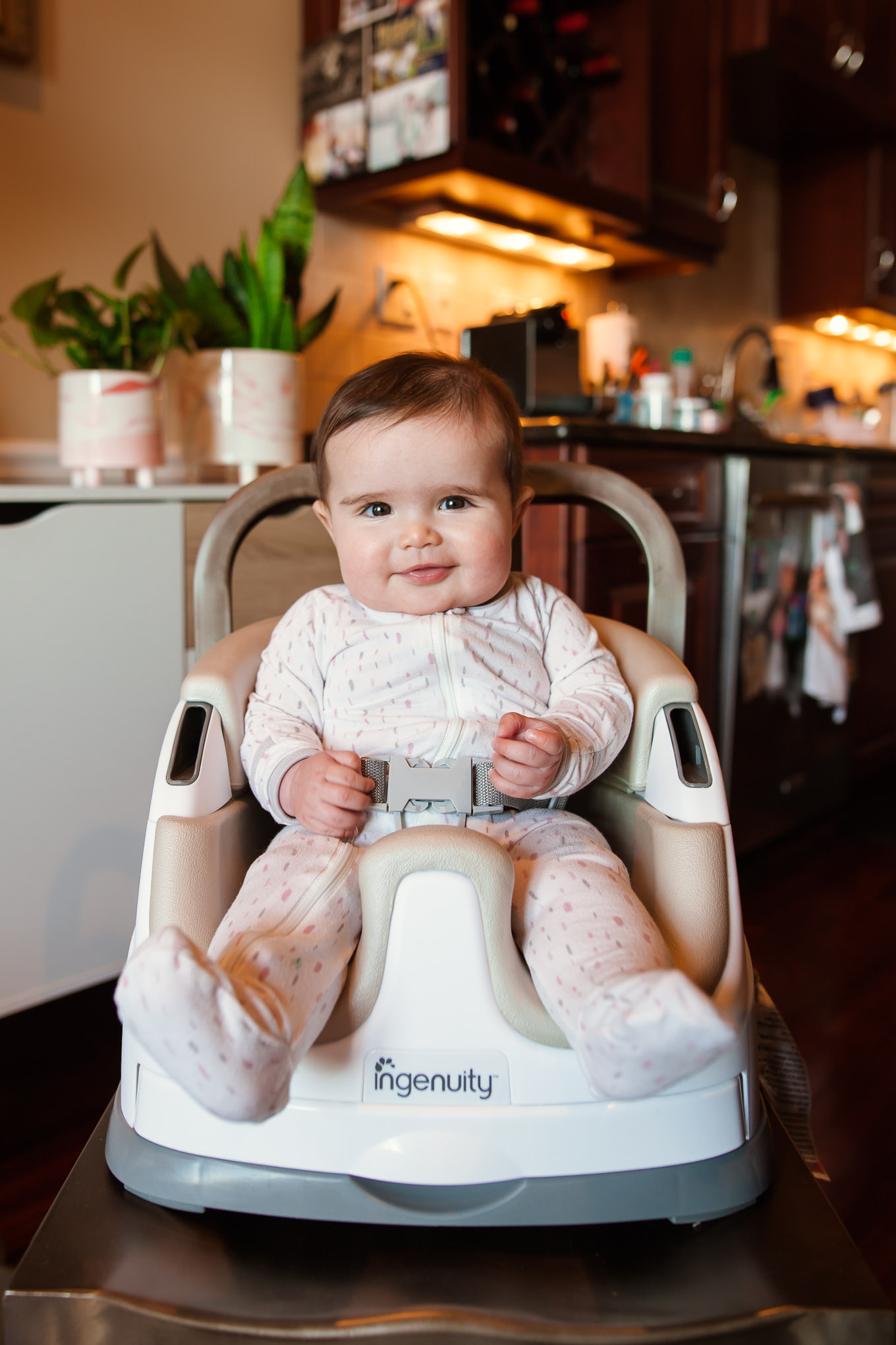 Ingenuity Baby Seat by popular Chicago mommy blog, Glass of Glam: image of a baby sitting in a Ingenuity baby seat.