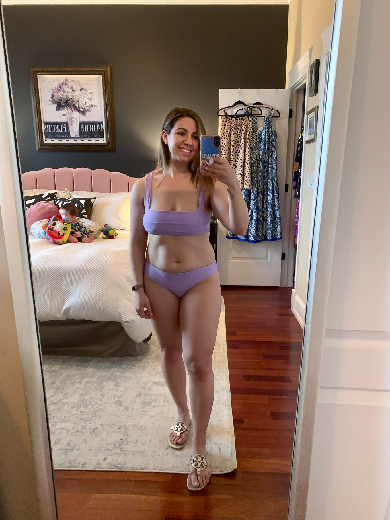 At Home Swimwear Try On by popular Chicago fashion blog, Glass of Glam: image of a woman standing in her master bedroom and wearing a light purple bikini. 