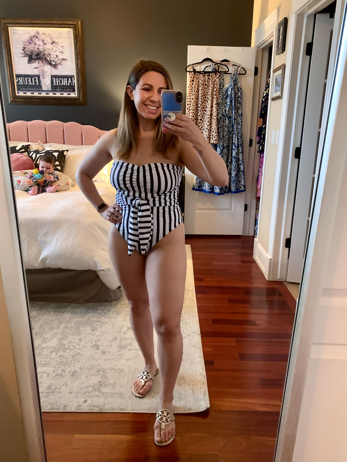 At Home Swimwear Try On by popular Chicago fashion blog, Glass of Glam: image of a woman standing in her master bedroom and wearing a SheIn Striped Knot Waist Bandeau One Piece Swimsuit.
