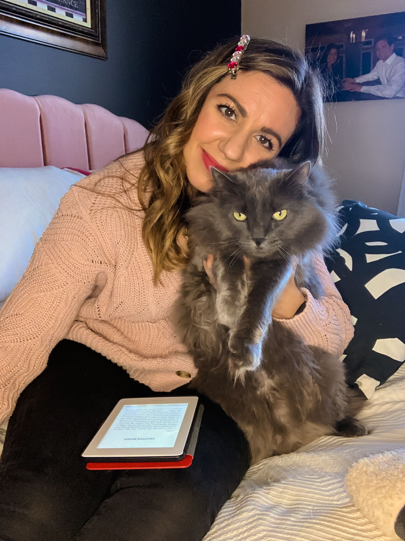 Quarantine Reading List by popular Chicago lifestyle blog, Glass of Glam: image of a woman sitting on her bed while holding her cat and an iPad. 