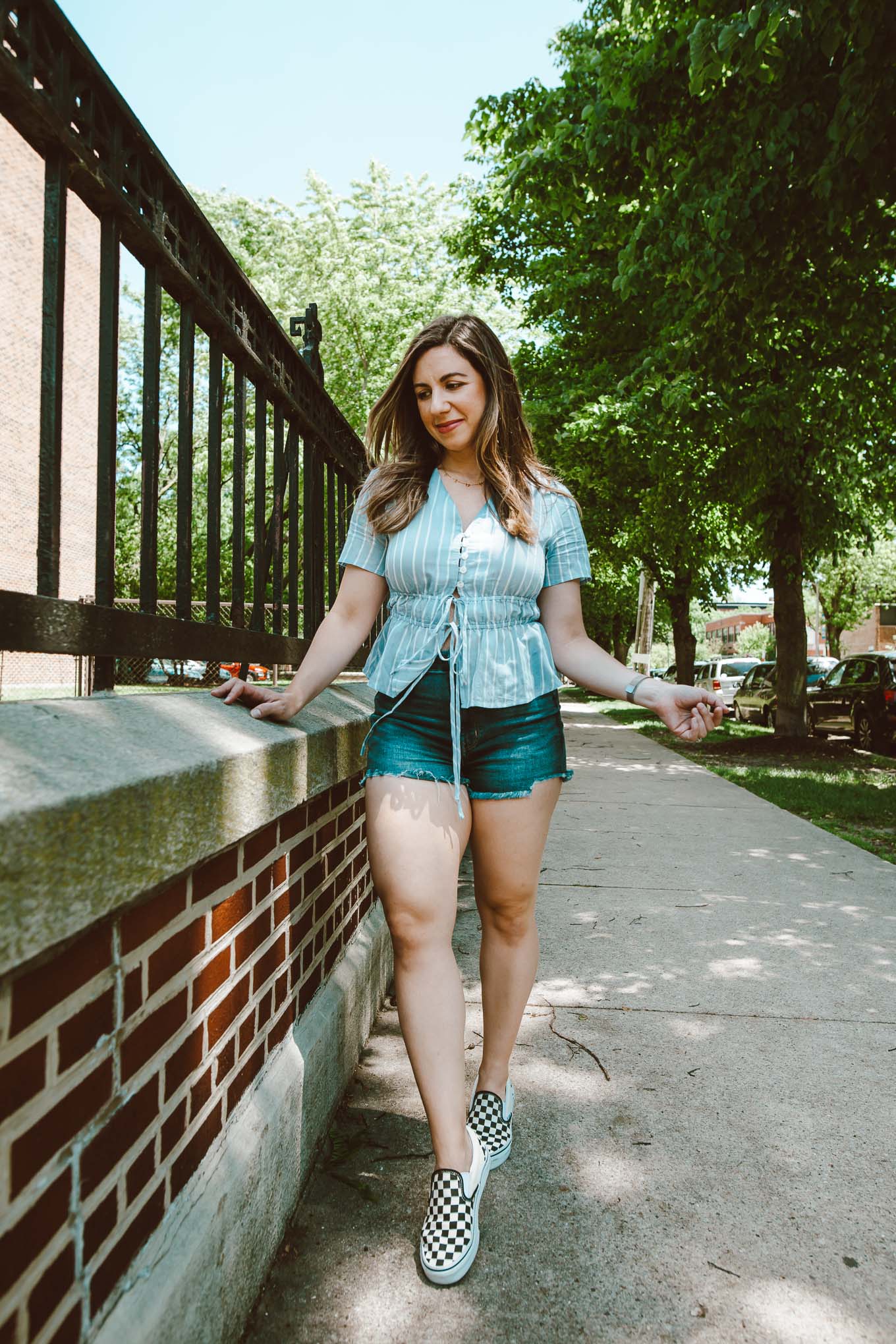  Curvy Shorts by popular Chicago fashion blog, Glass of Glam: image of Roxanne Birmbaum wearing a SHEIN Buttoned Tie Front Striped Peplum Blouse, American Eagle AE Ne(x)t Level Curvy Denim High-Waisted Short Short, and Nordstrom Classic Slip-On Sneaker VANS.