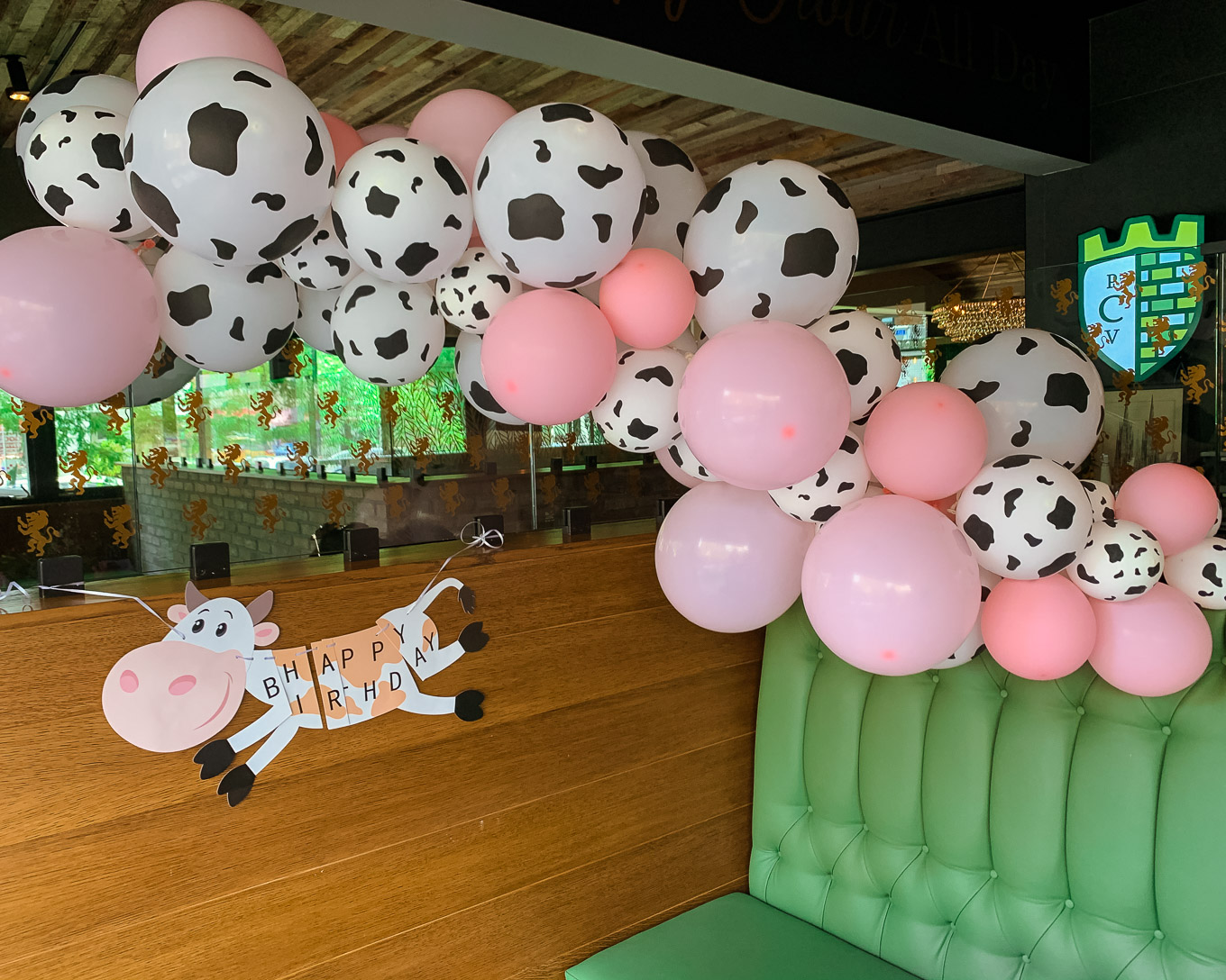1st Birthday by popular Chicago lifestyle blog, Glass of Glam: image of a Amazon QIYNAO White and Blacke Dairy Cow Happy Birthday Banner and Amazon Finypa Funny Cow Party Decorations Balloon 85pcs Arch Garland.