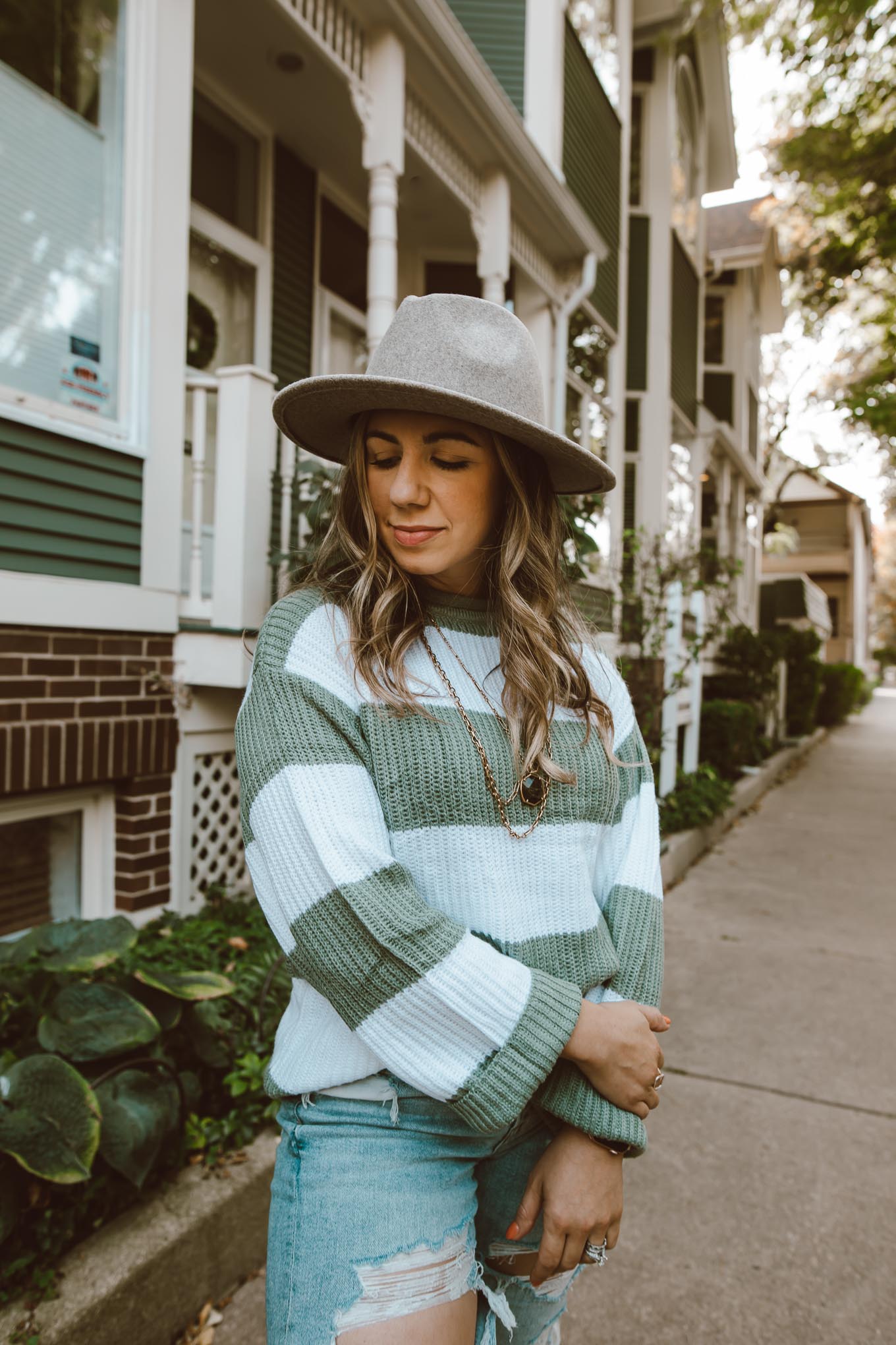 Fall Hat by popular Chicago fashion blog, Glass of Glam: image of a woman outside wearing a Amazon ZESICA Women's Long Sleeve Crew Neck Striped Color Block Comfy Loose Oversized Knitted Pullover Sweater, American Eagle Mom Jean, Nordstrom Vans sneakers, Amazon Lisianthus Women Belt Buckle Wool Wide Brim Fedora Hat, and Kendra Scott Davis Vintage Gold Multi Strand Necklace In Golden Obsidian.