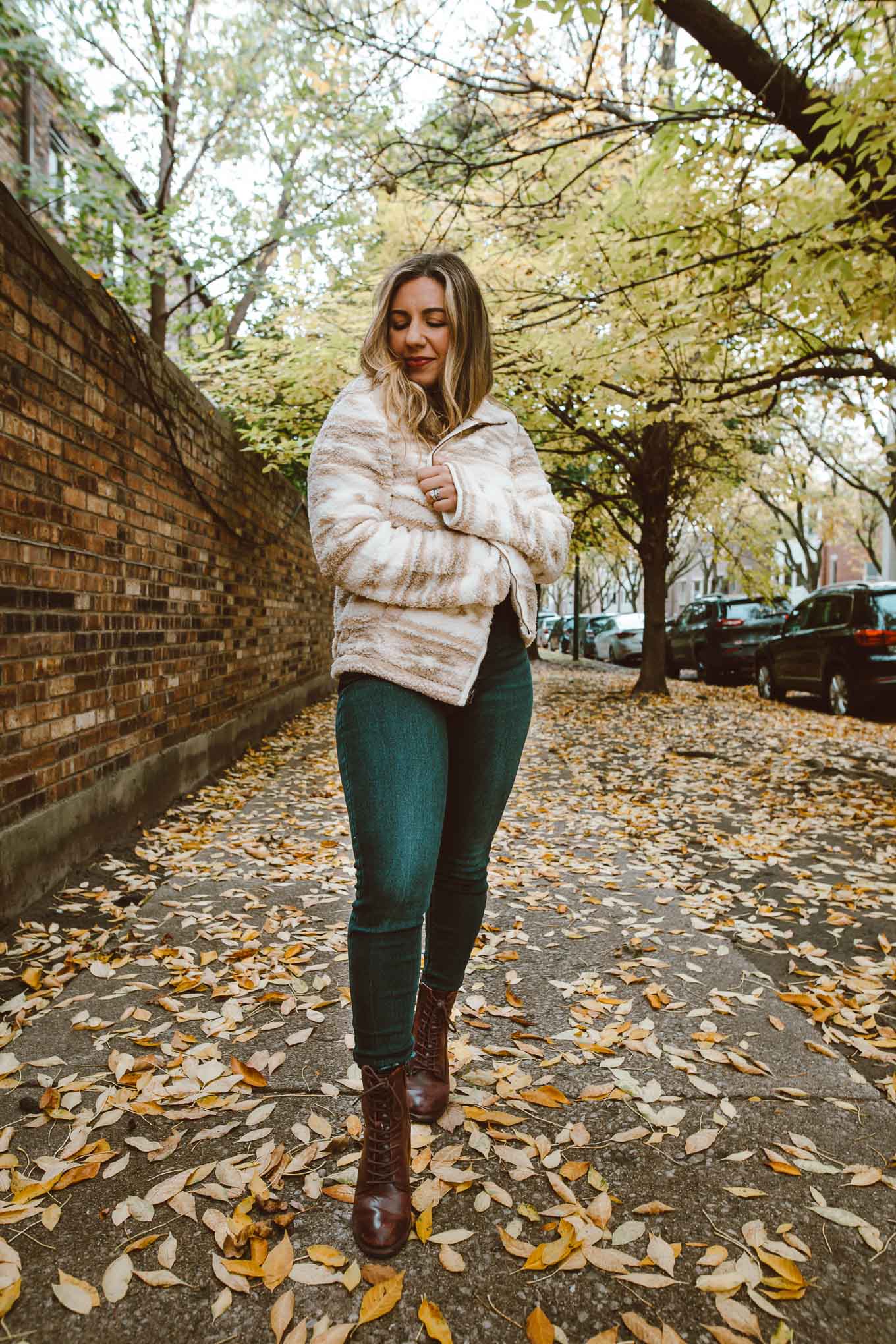 Sherpa Clothing by popular Chicago fashion blog, Glass of Glam: image of a woman walking through some leaves and wearing a red shirt, Old Navy Rockstar Jeans, Old Navy Cozy Sherpa Zip-Front Jacket for Women, and Patricia Nash Womens Sicily Leather Closed Toe Ankle Fashion Boots.