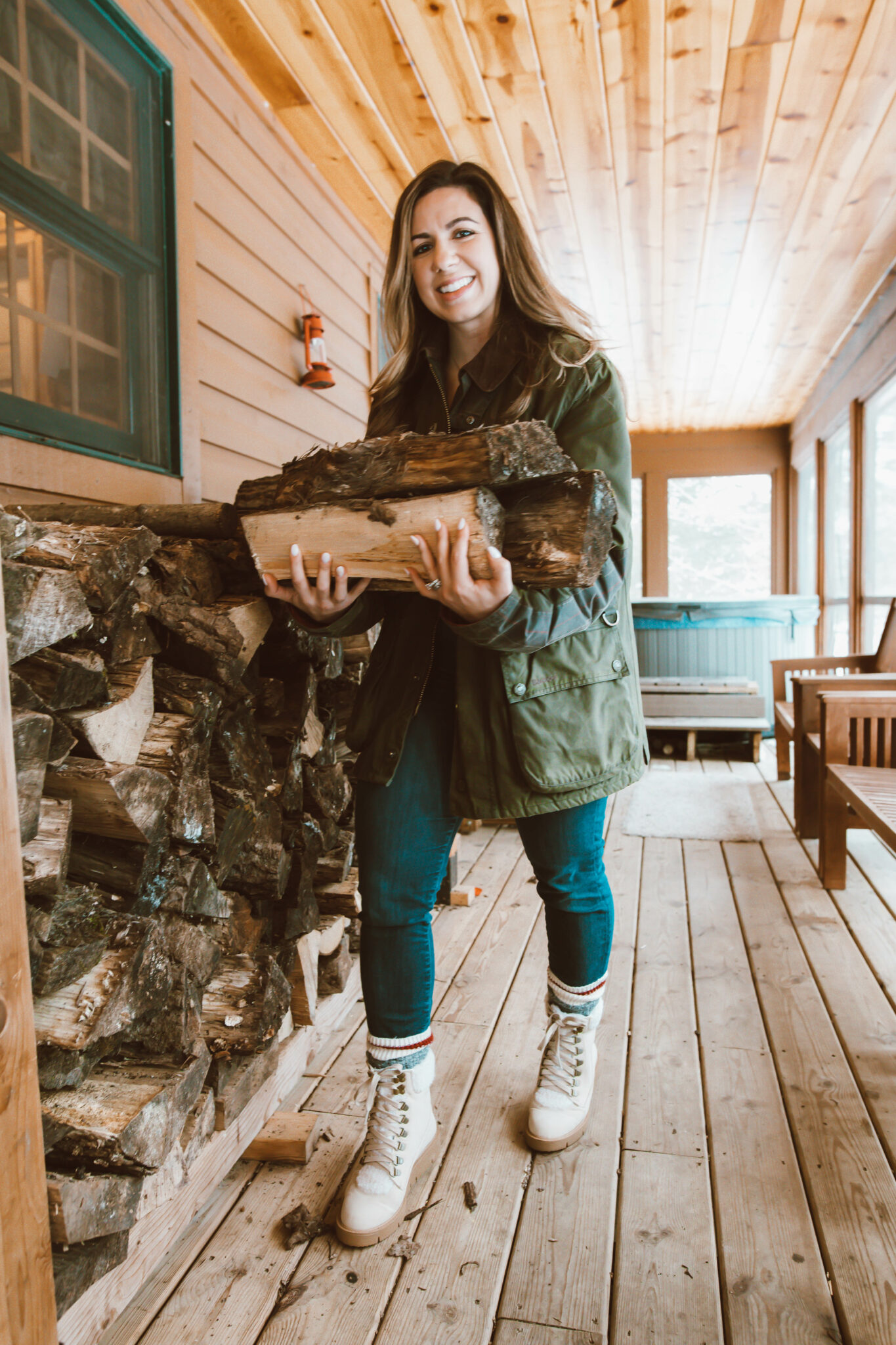Olive Clothing by popular Chicago fashion blog, Glass of Glam: image of a woman standing on a cabin deck and wearing a waffle henley, Agolde denim, Just Fab boots, socks, Dan's Barbour Jacket