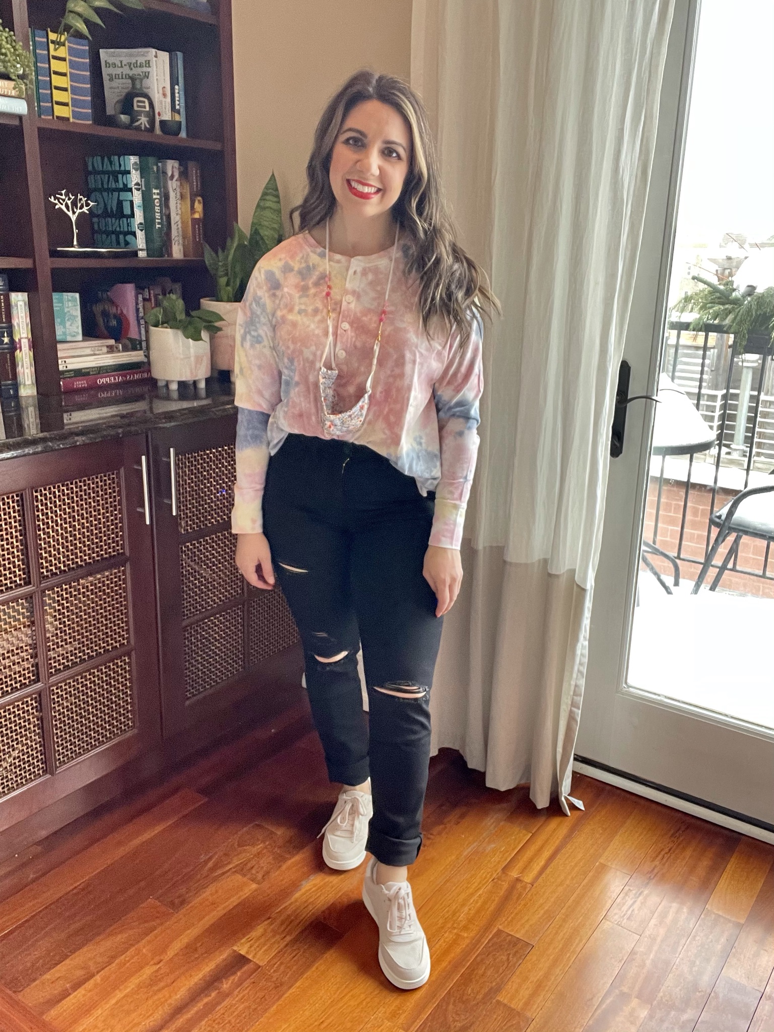Spring Outfits from Old Navy by popular Chicago fashion blog, Glass of Glam: image of a woman wearing a Old Navy tie dye long sleeve top, black distressed jeans, and sneakers. 