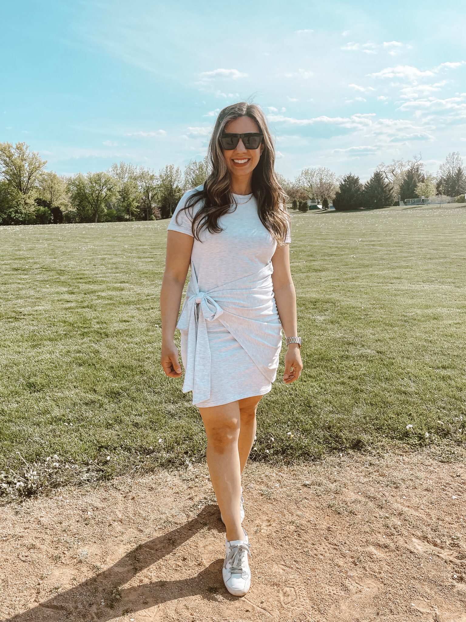 Amazon Dress by popular Chicago fashion blog, Glass of Glam: image of a woman standing outside in a field and wearing a grey Amazon dress, white sneakers, and gold Gorjana necklace. 